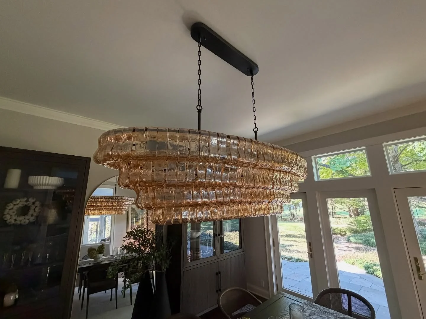 An in-person look at a beautiful chandelier we custom made for a client in Geneva, IL! The amber colored glass pairs perfectly with the dark wood finishes and moody natural lighting. We can make this fixture in virtually any metal finish and glass co