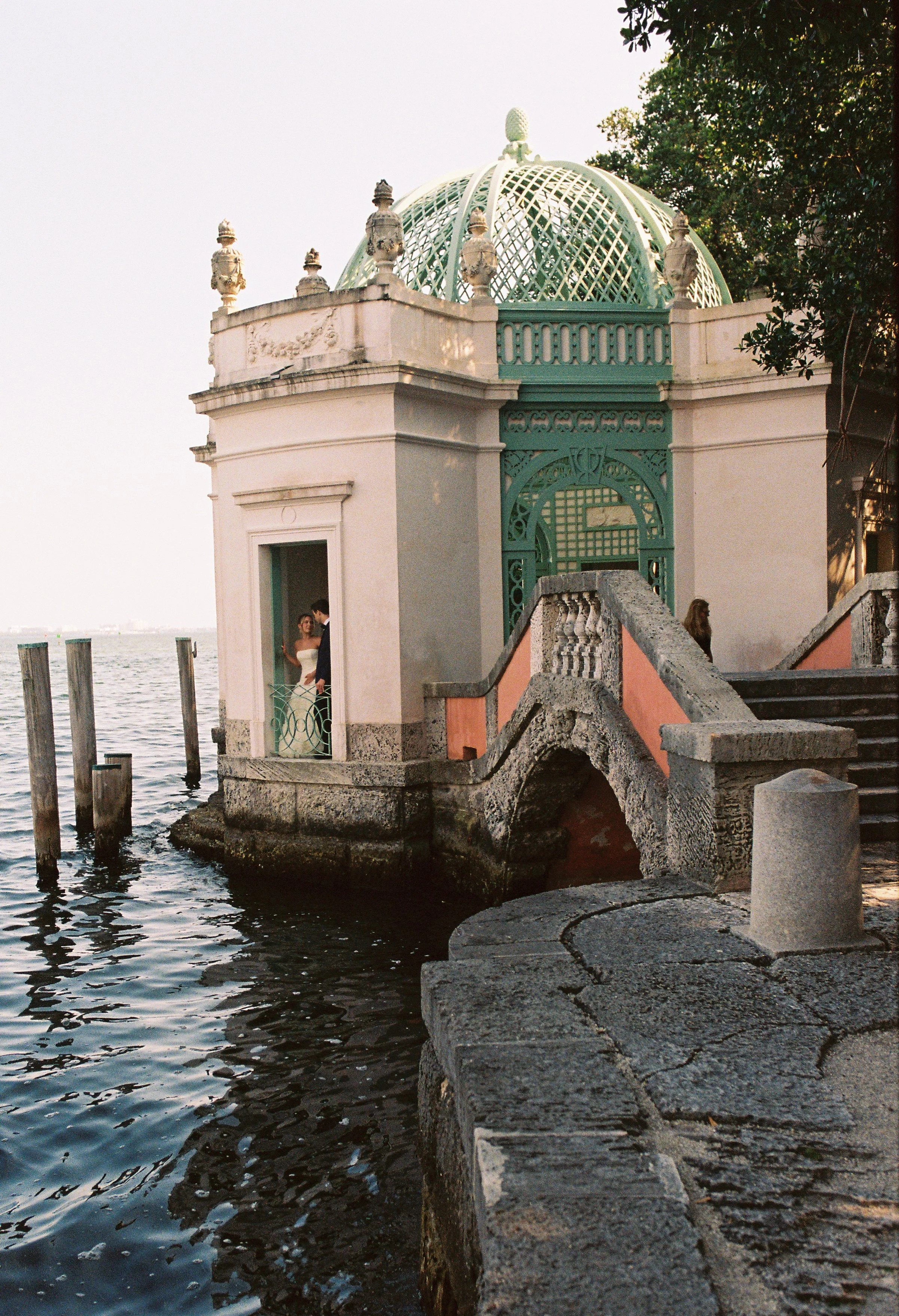 Couple standing in a doorway beside the iconic waterfront tea house at Vizcaya Museum and Gardens in Miami. (Copy)