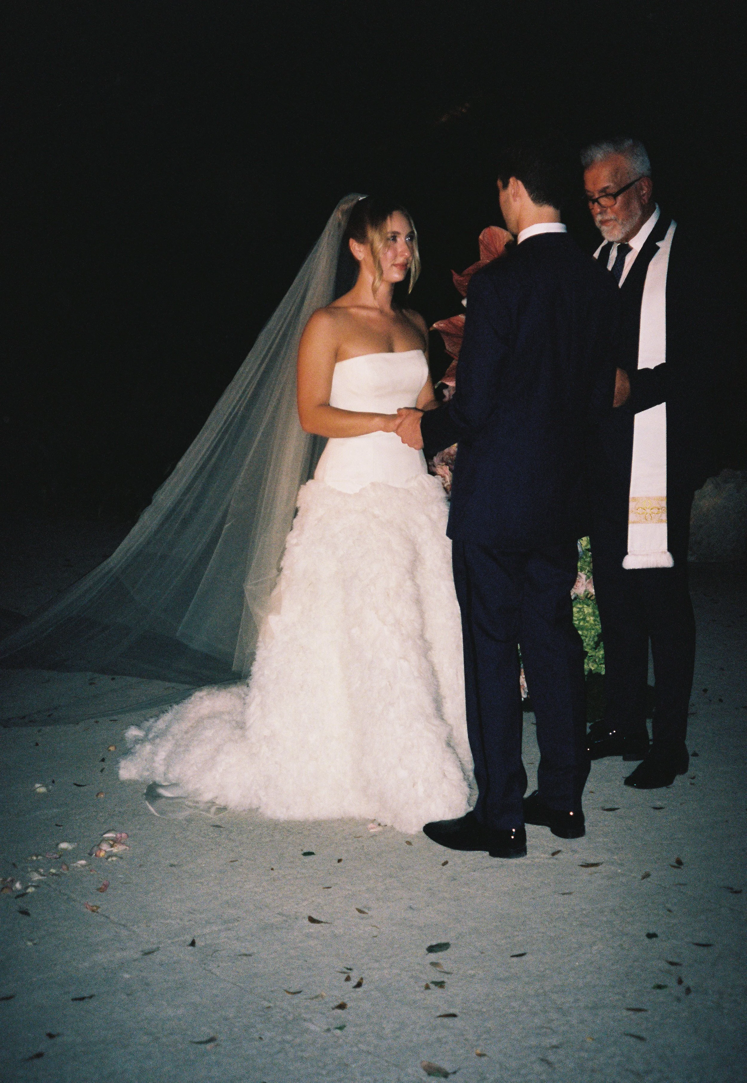 Bride and groom exchanging vows during an evening ceremony at Vizcaya Museum and Gardens. (Copy)