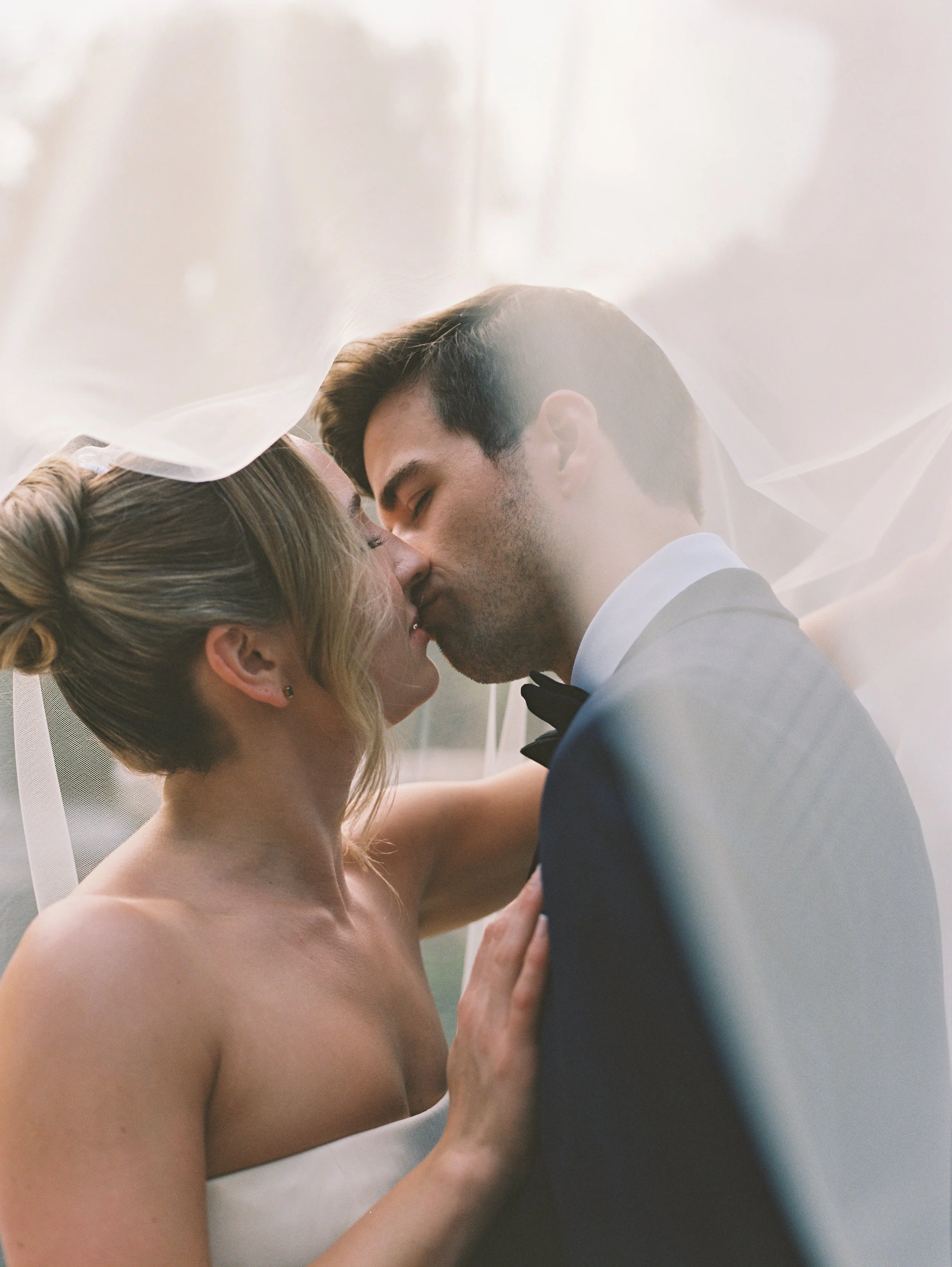 Romantic close-up of the bride and groom kissing beneath the veil during their Vizcaya Museum and Gardens wedding. (Copy)