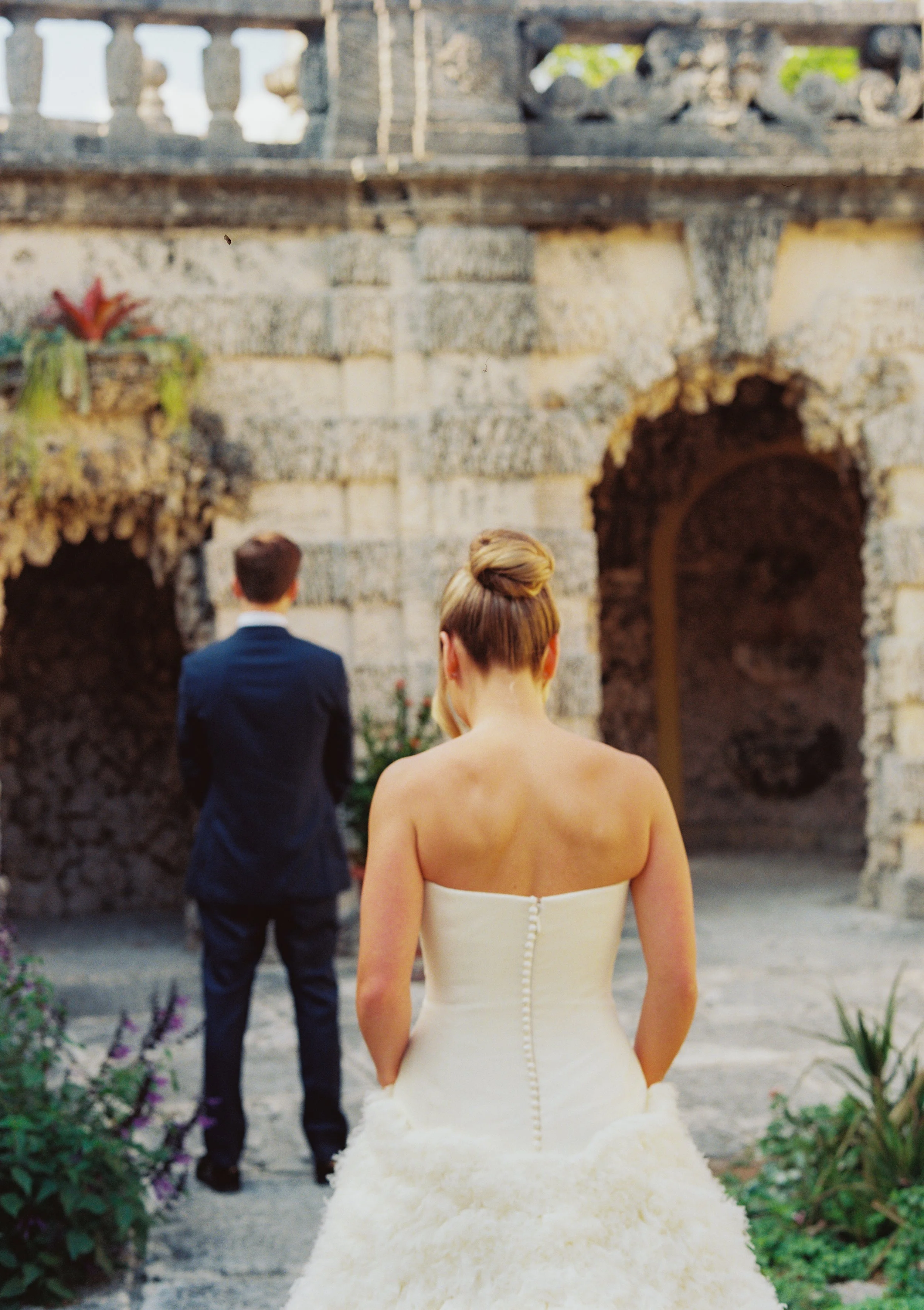 Bride walking toward the groom for their first look in the historic garden architecture at Vizcaya Museum and Gardens. (Copy)