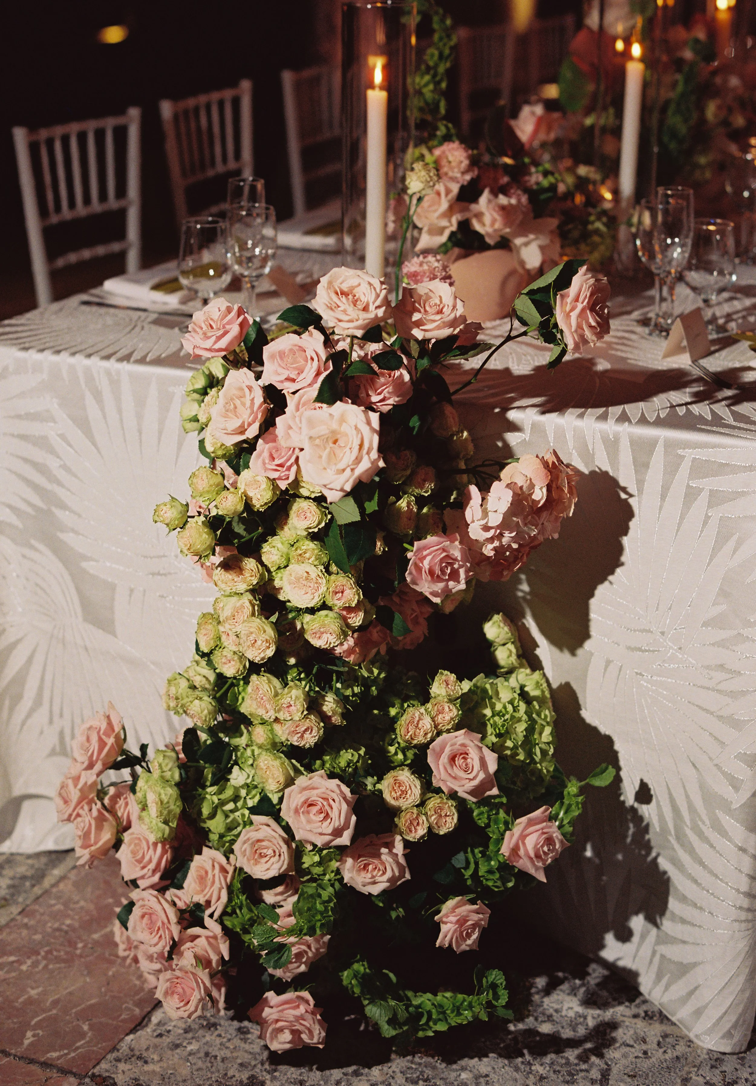 Romantic pink rose floral arrangement cascading from the reception table during an elegant Vizcaya Museum and Gardens wedding reception. (Copy)