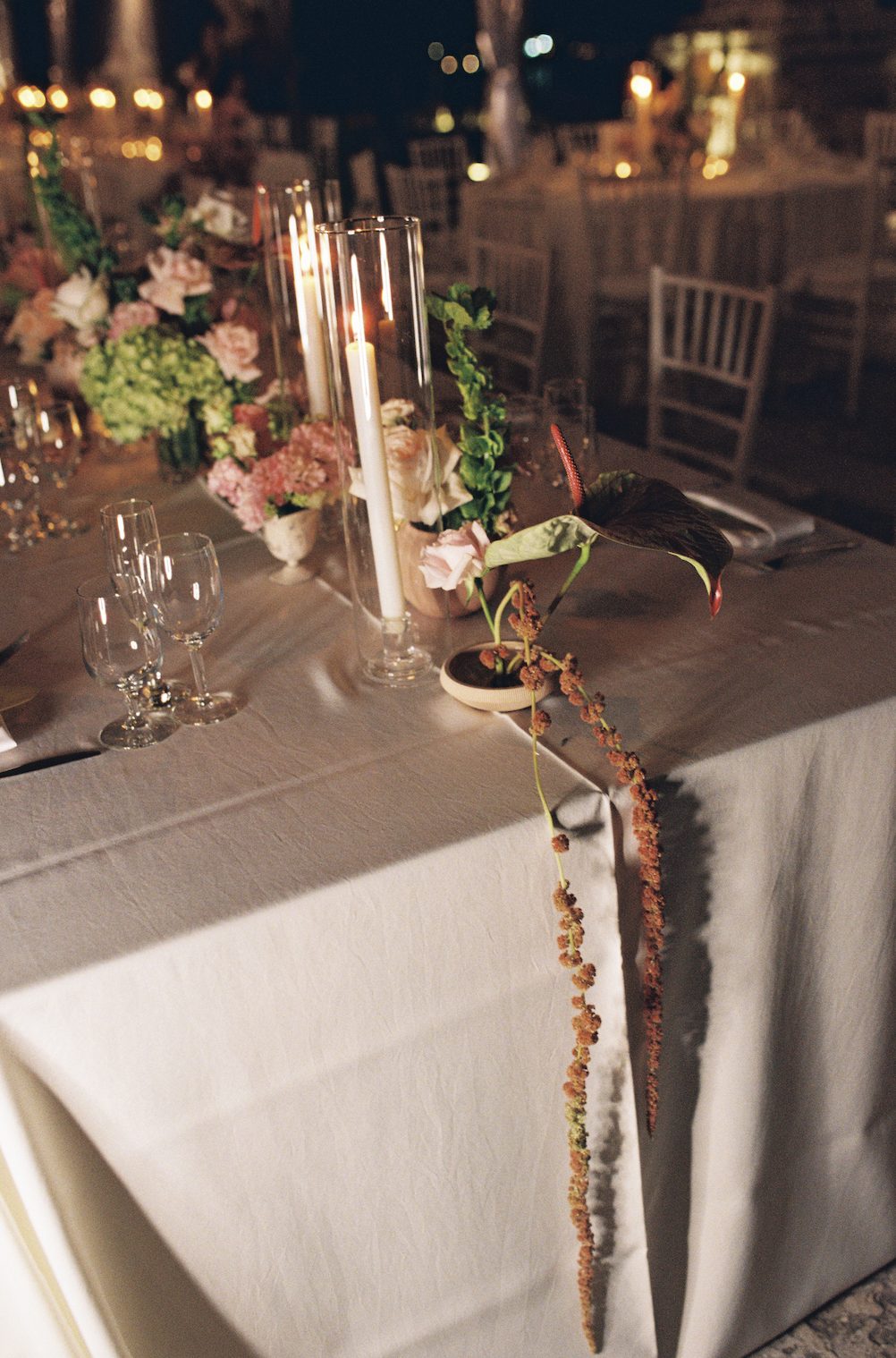 Candlelit reception table with romantic florals and glass candle holders during an evening Vizcaya Museum and Gardens wedding reception. (Copy)