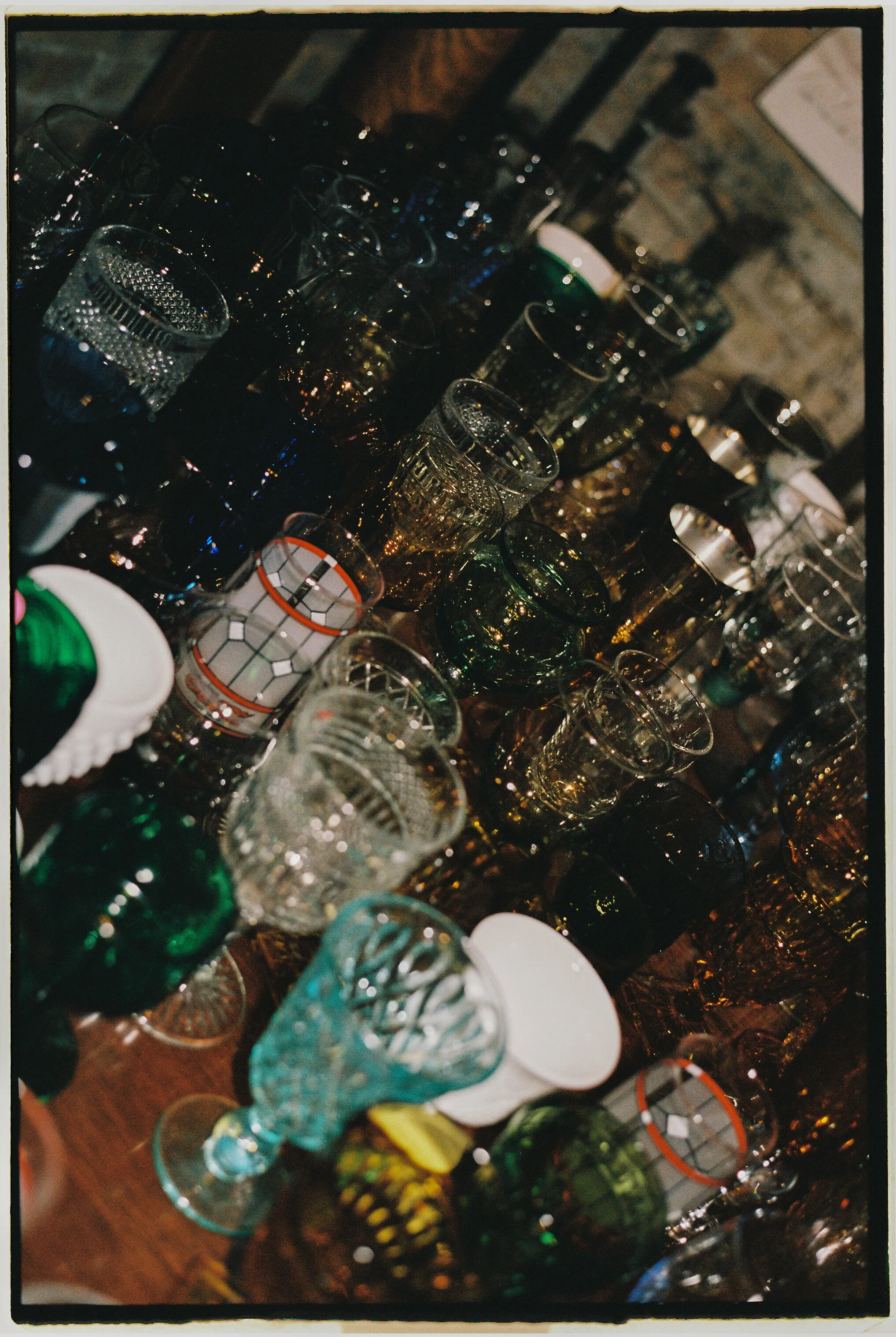 Collection of colorful vintage glassware arranged on a table at Salvage One reception