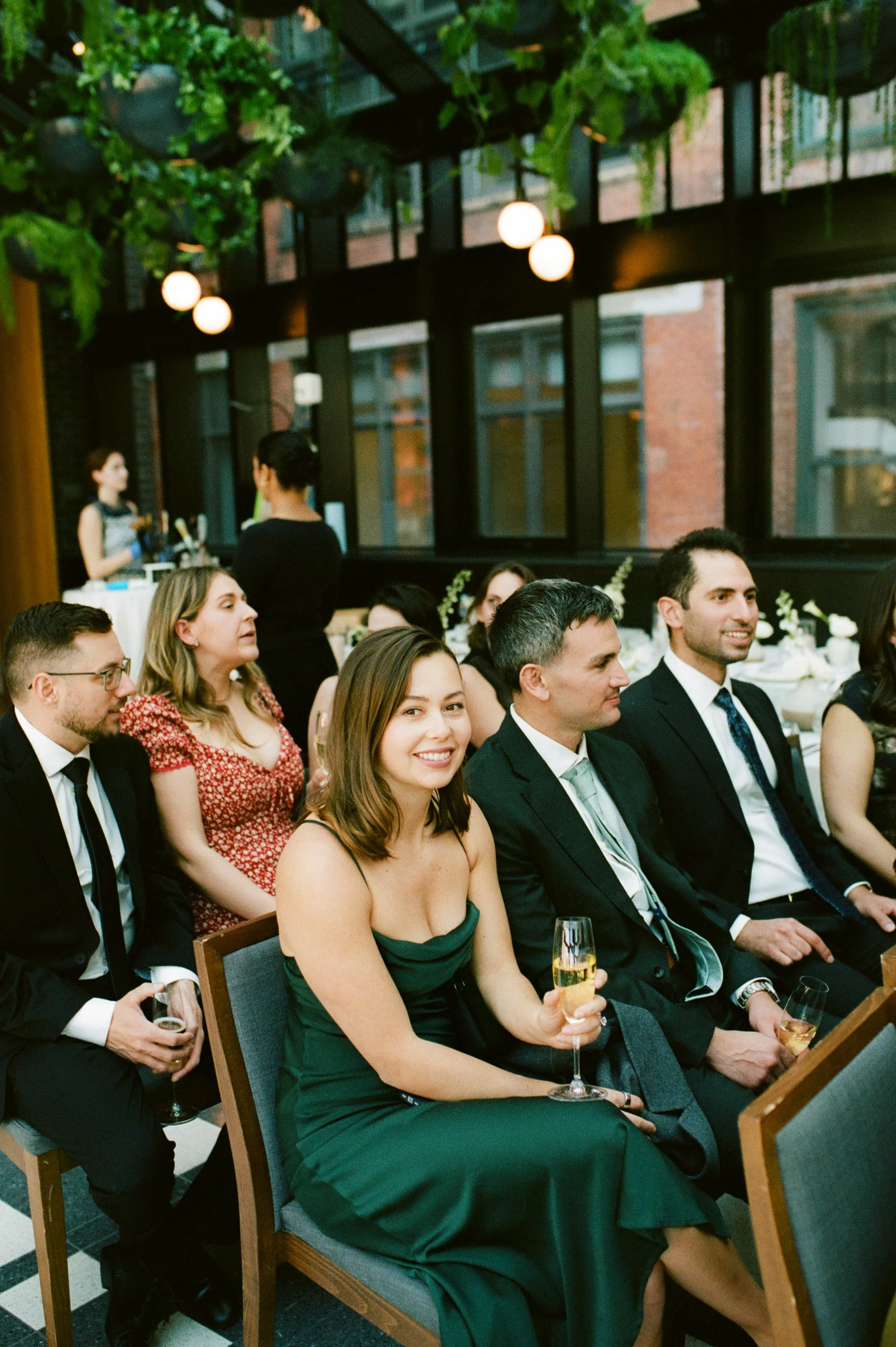Wedding guests seated during the ceremony at Shinola Hotel with greenery and natural light surrounding the space