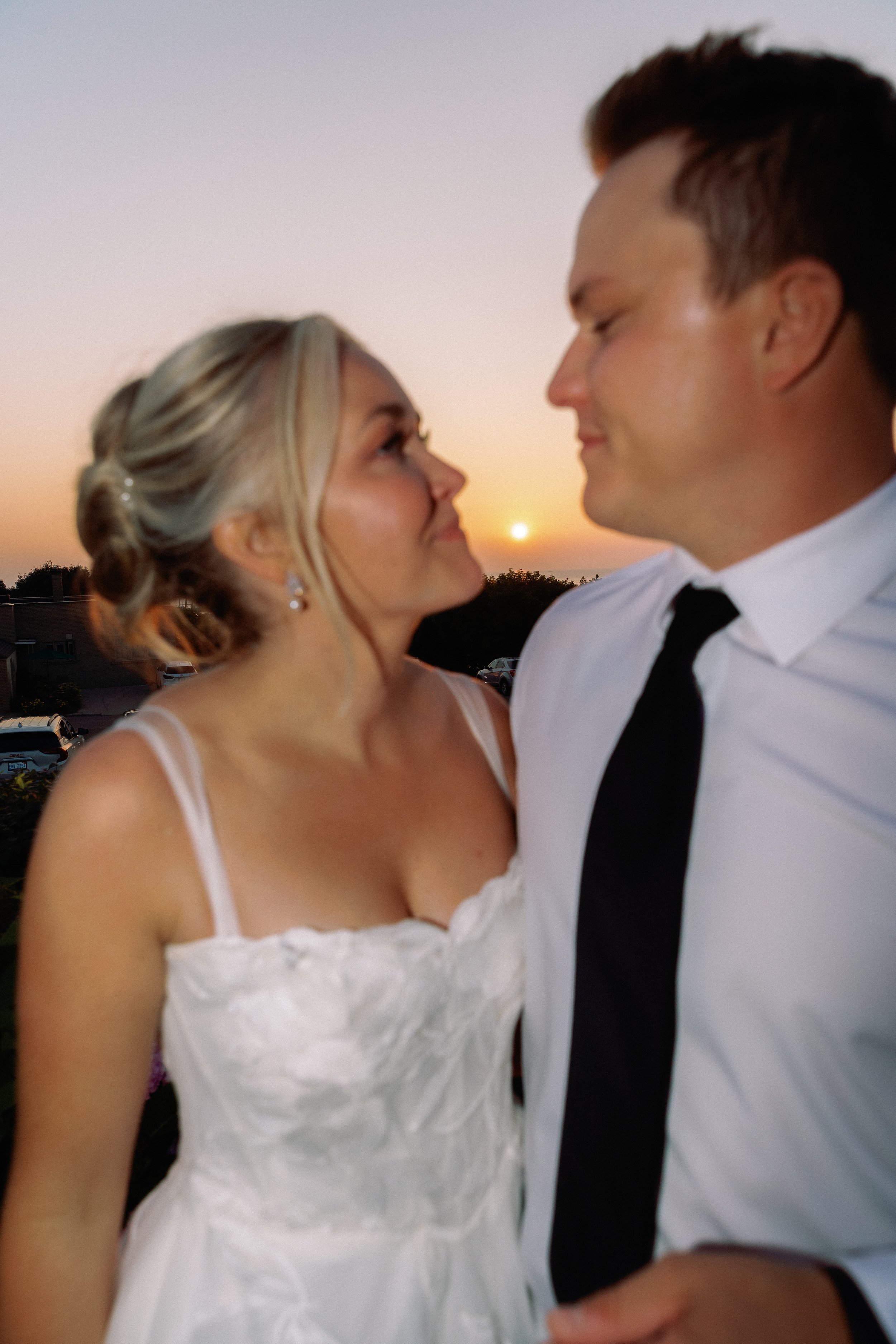 Newlyweds sharing a quiet moment together at sunset after their wedding celebration.