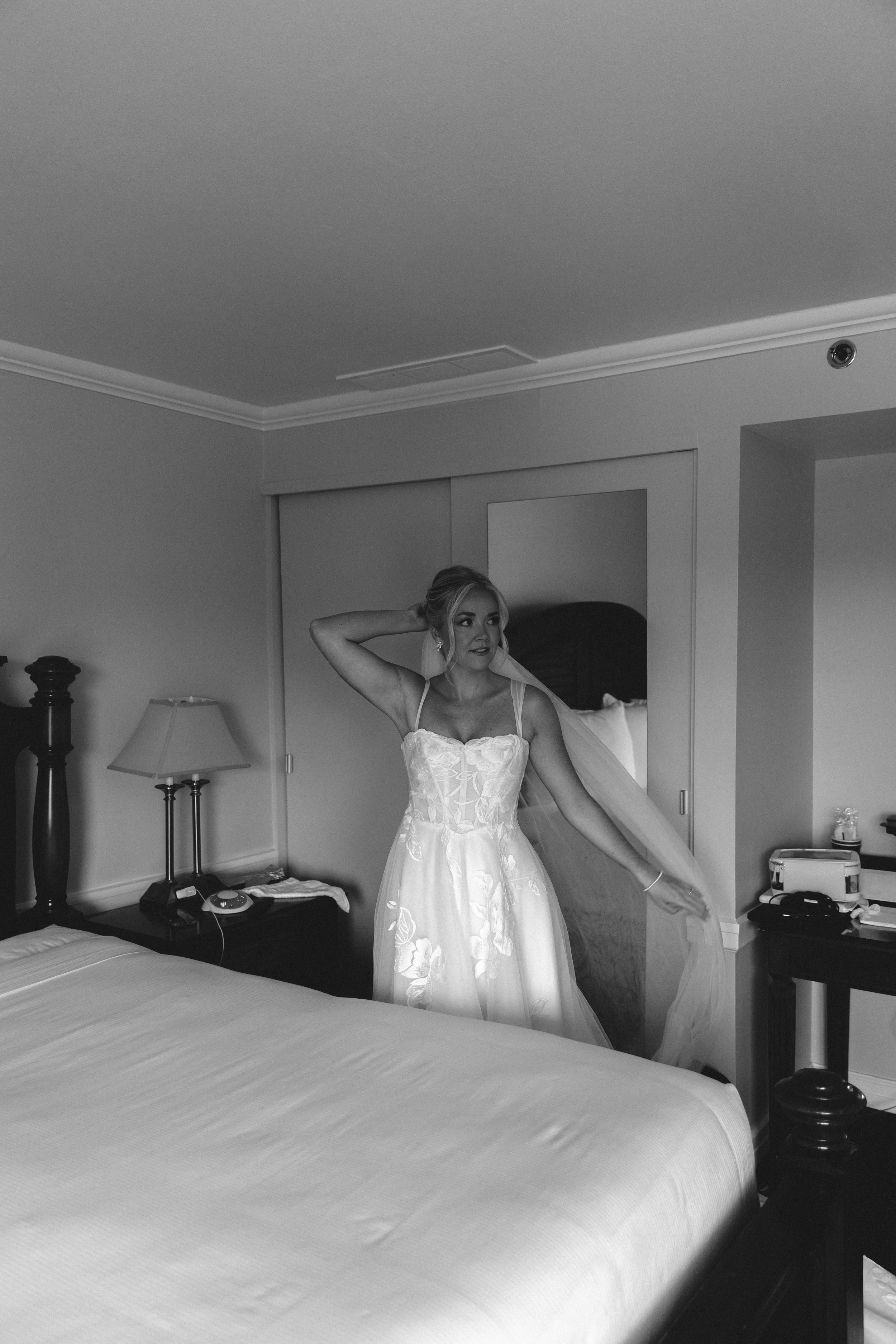 Black and white bridal portrait in a hotel room before the wedding ceremony at Stafford's Perry Hotel.
