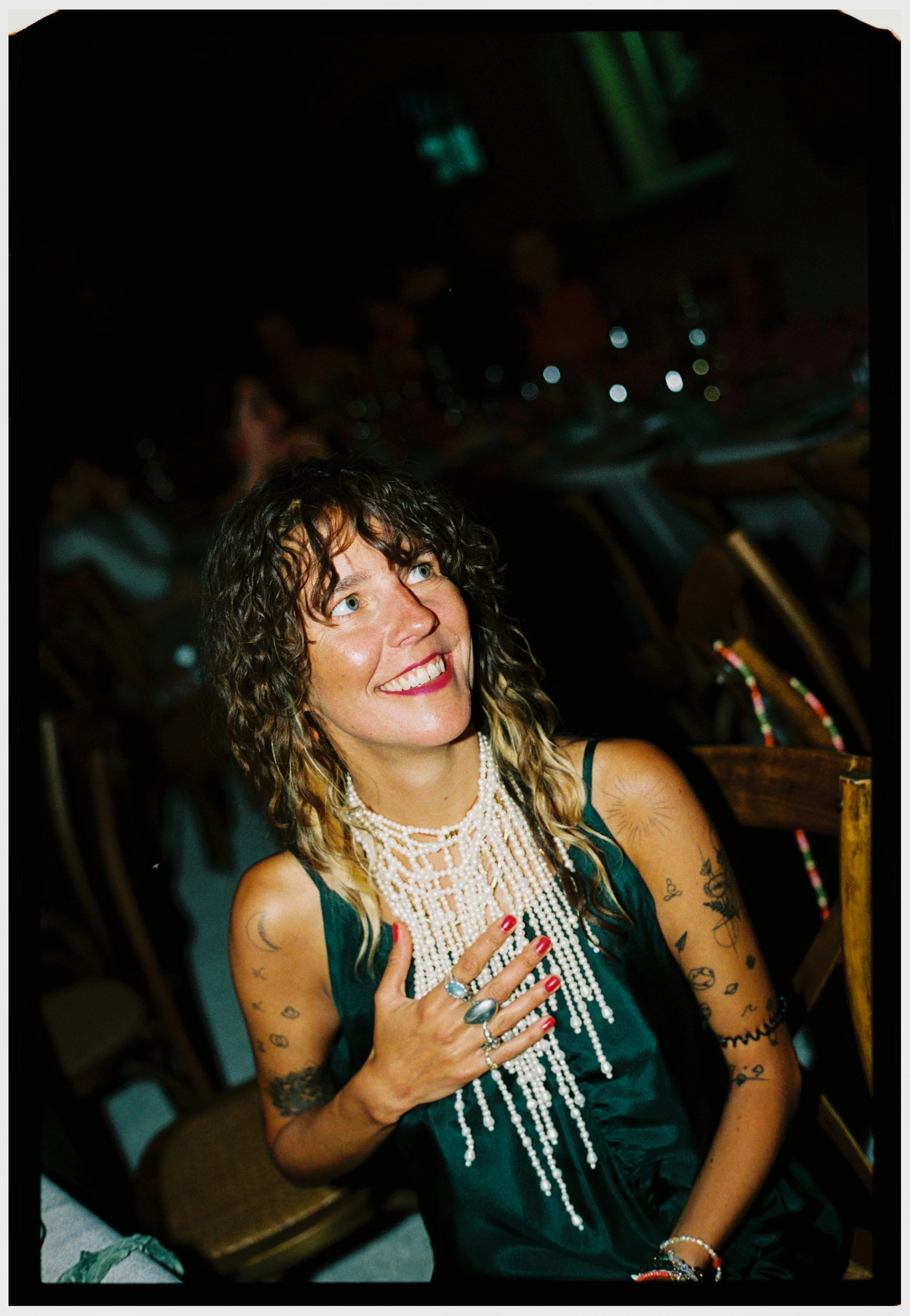 Wedding guest smiling during the evening reception festivities.