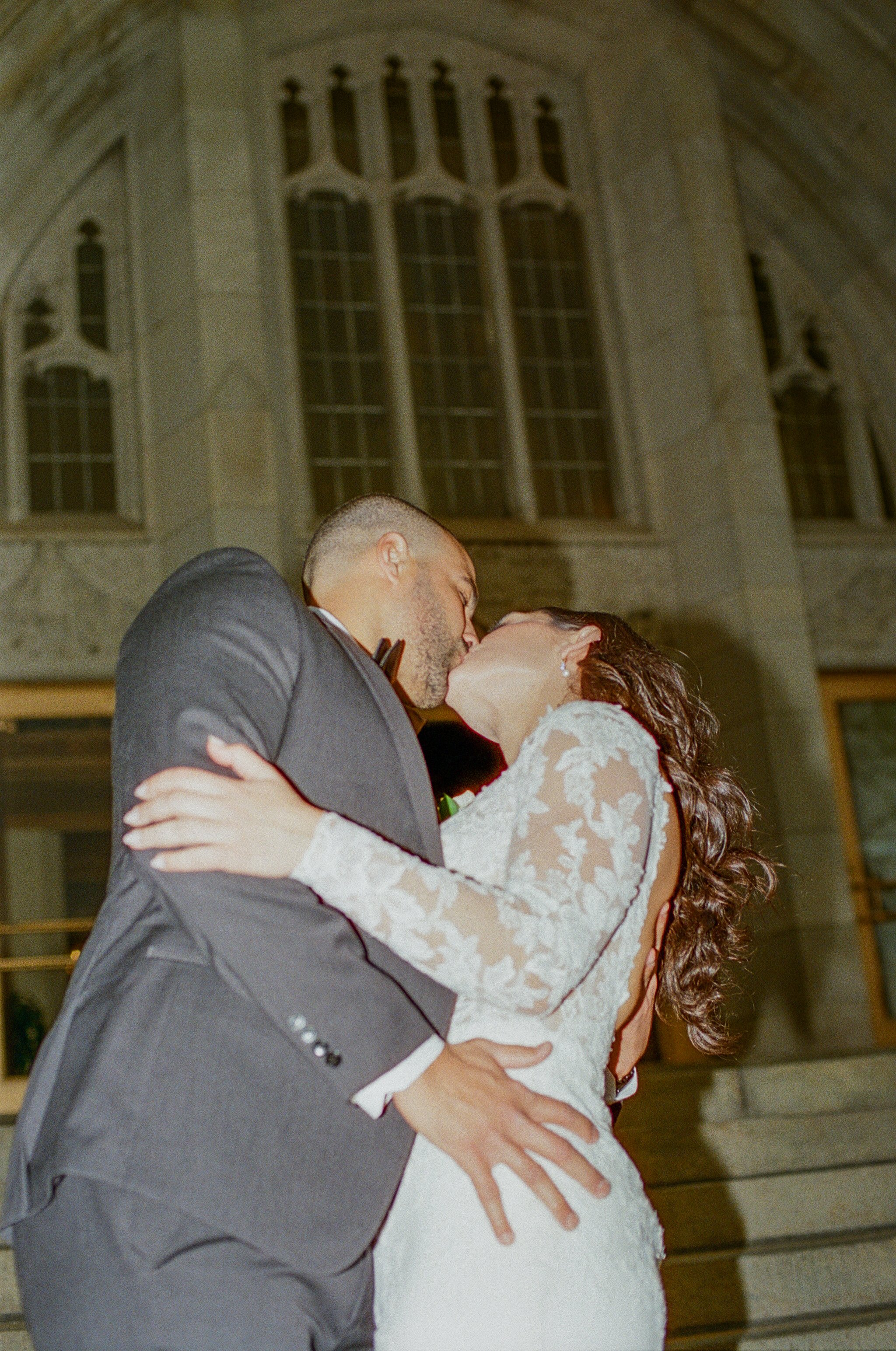 Close-up film-style photo of the newlyweds kissing during their downtown Detroit wedding.