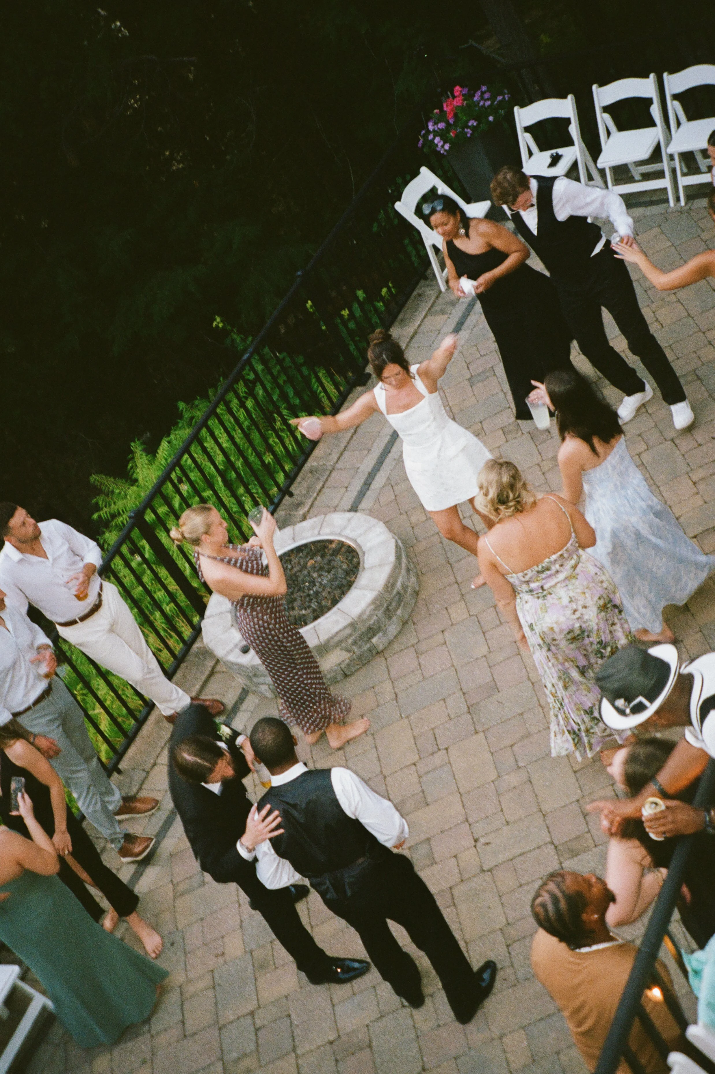 Candid overhead photo of wedding guests dancing together during a Northern Michigan backyard wedding reception.
