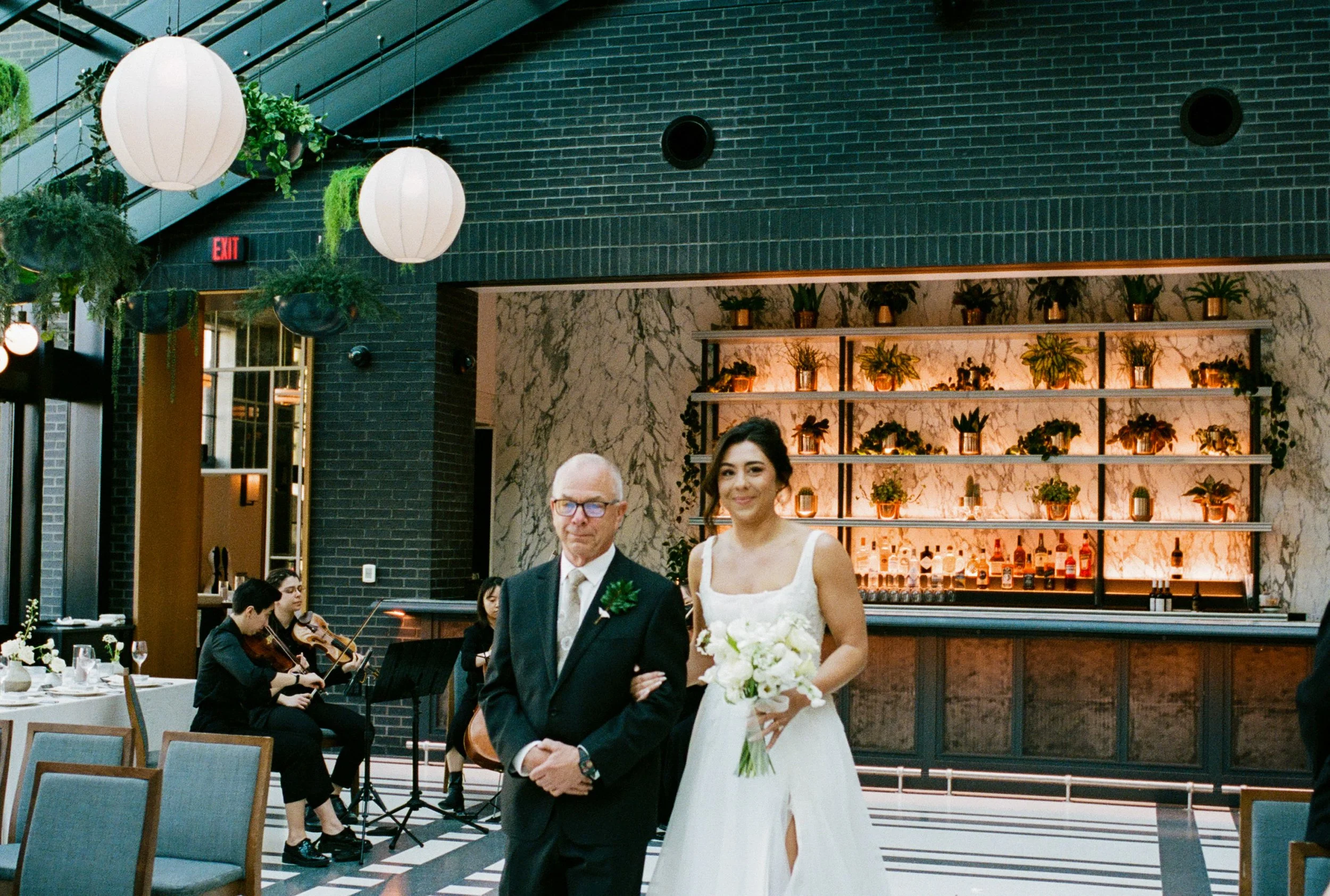 Bride walking down the aisle with her father during an intimate ceremony at Shinola Hotel in Detroit
