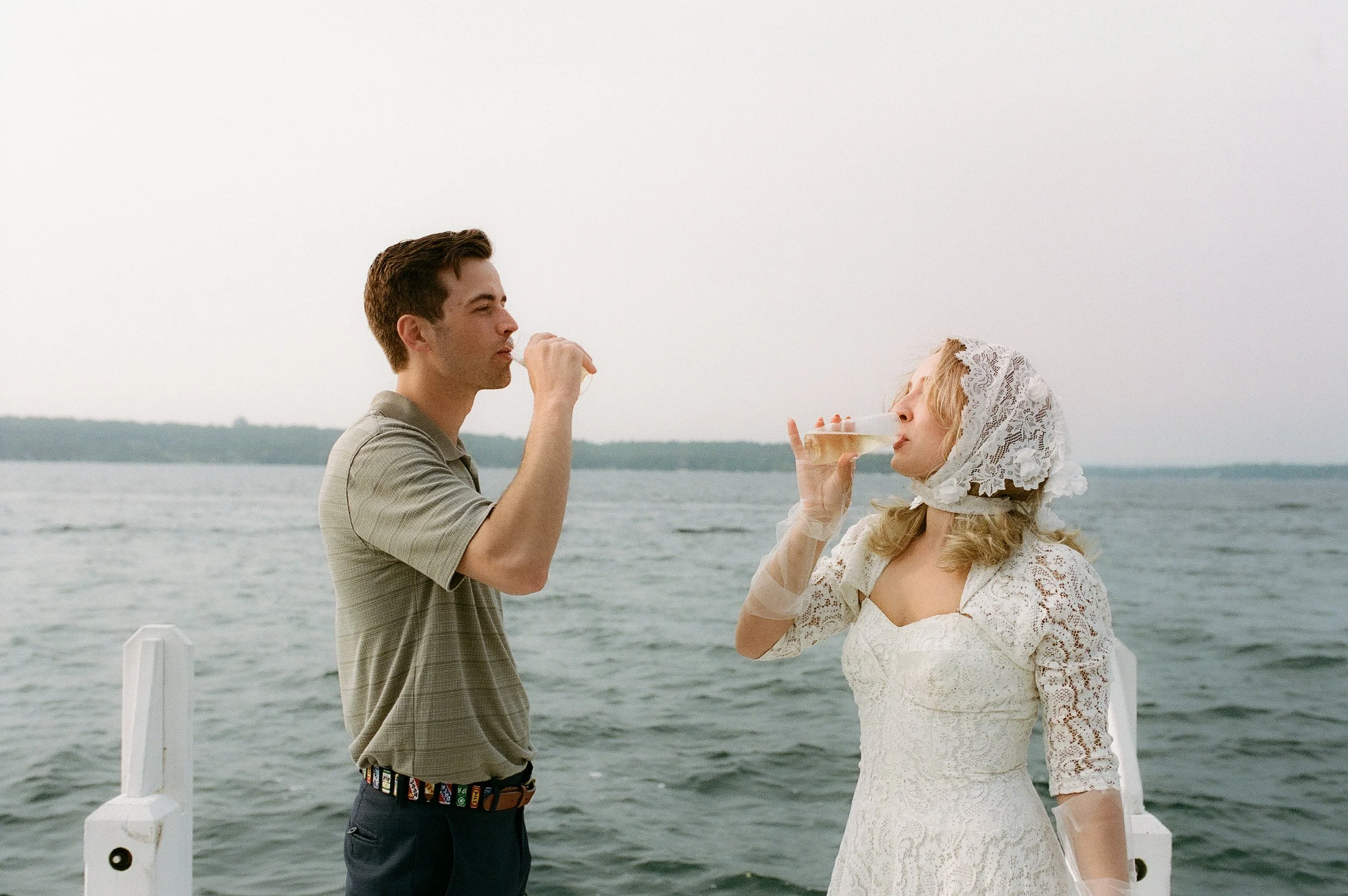 Bride and groom sipping champagne together on the water during a romantic Lake Geneva Engagement boat session.