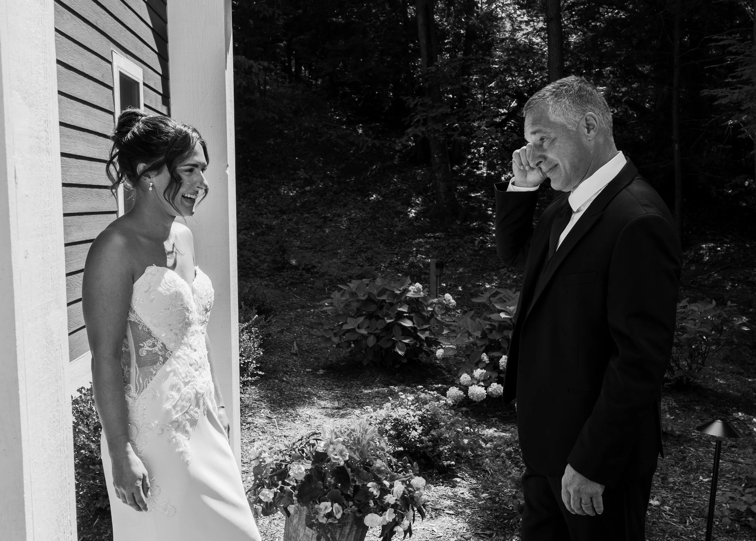 Emotional black and white photo of the bride and her father seeing each other before the Northern Michigan backyard wedding ceremony.