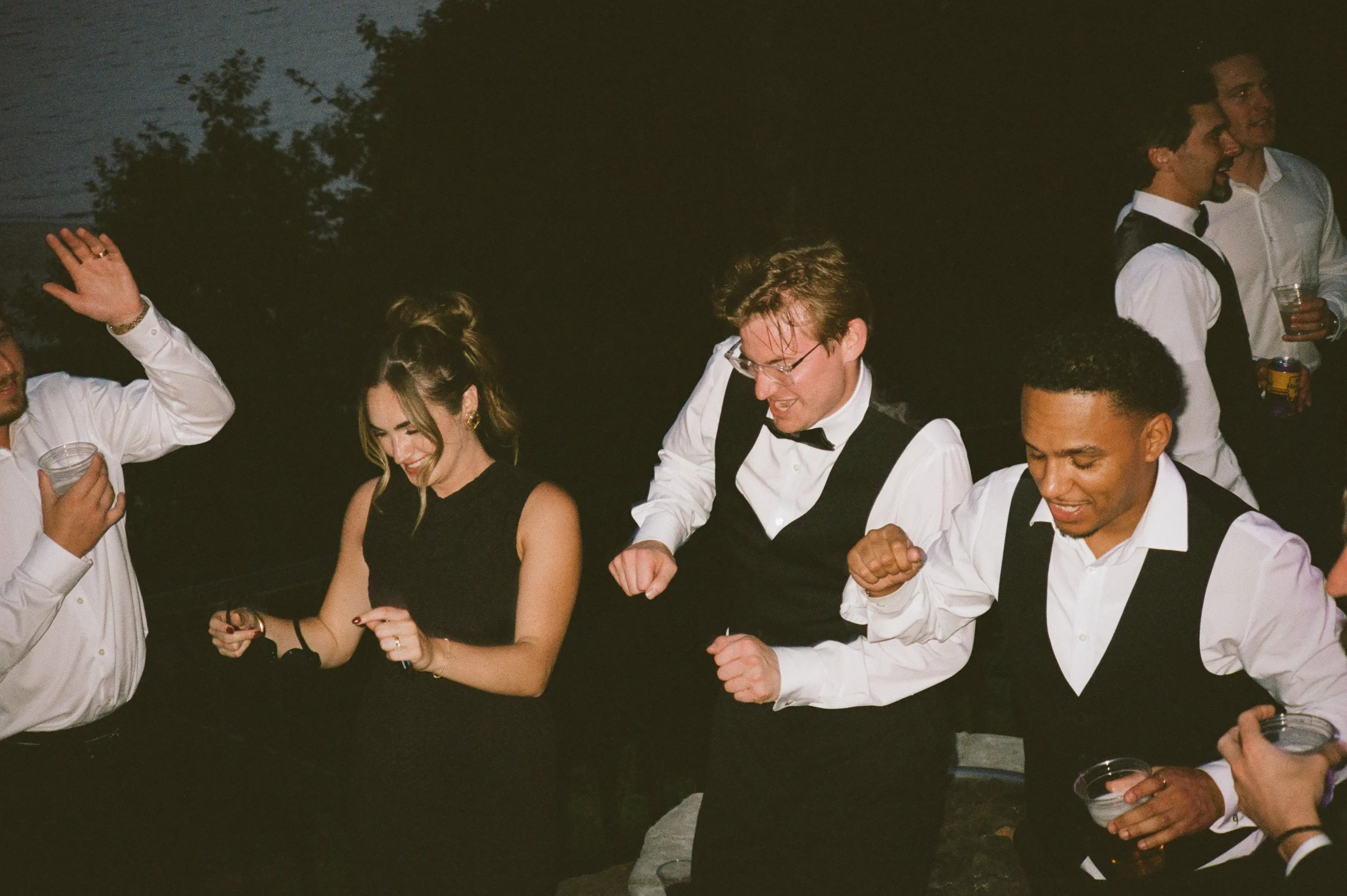 Wedding guests dancing at night during a Northern Michigan backyard wedding celebration.