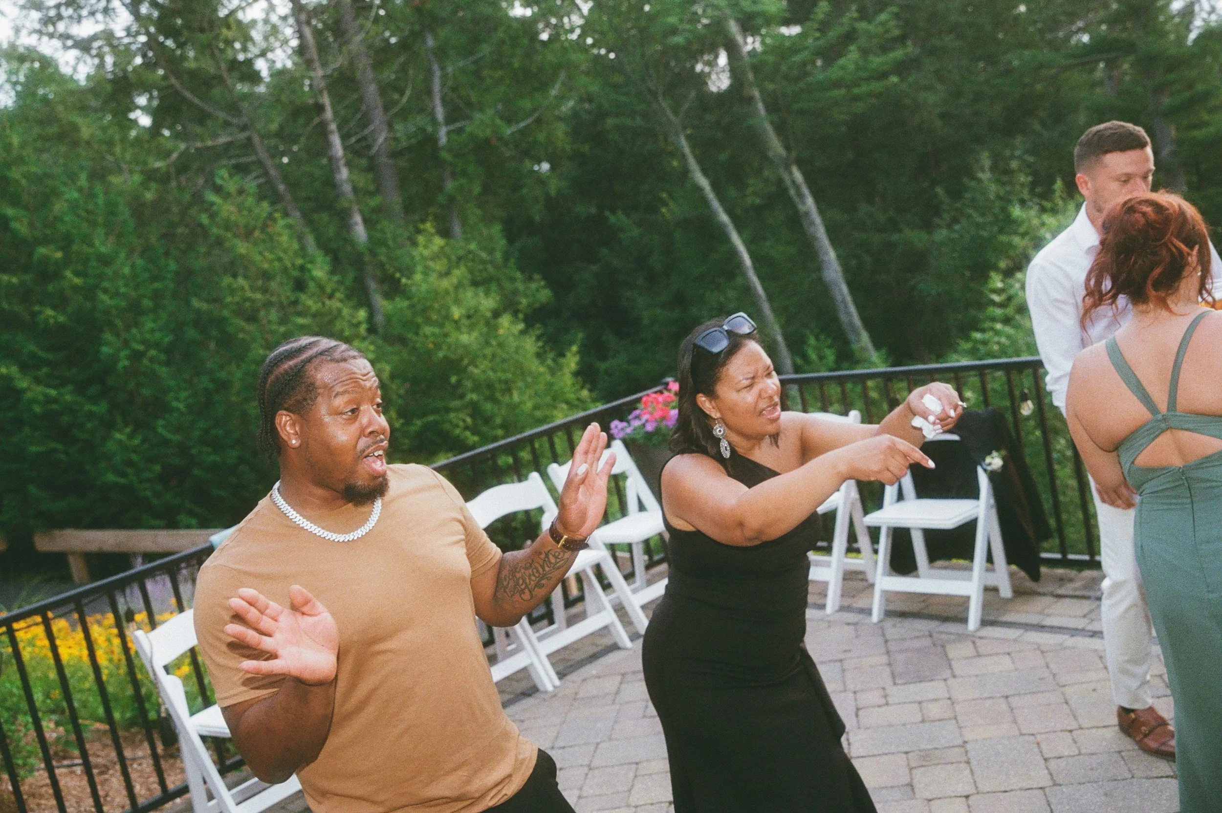 A couple of wedding guests enjoy dancing during reception.