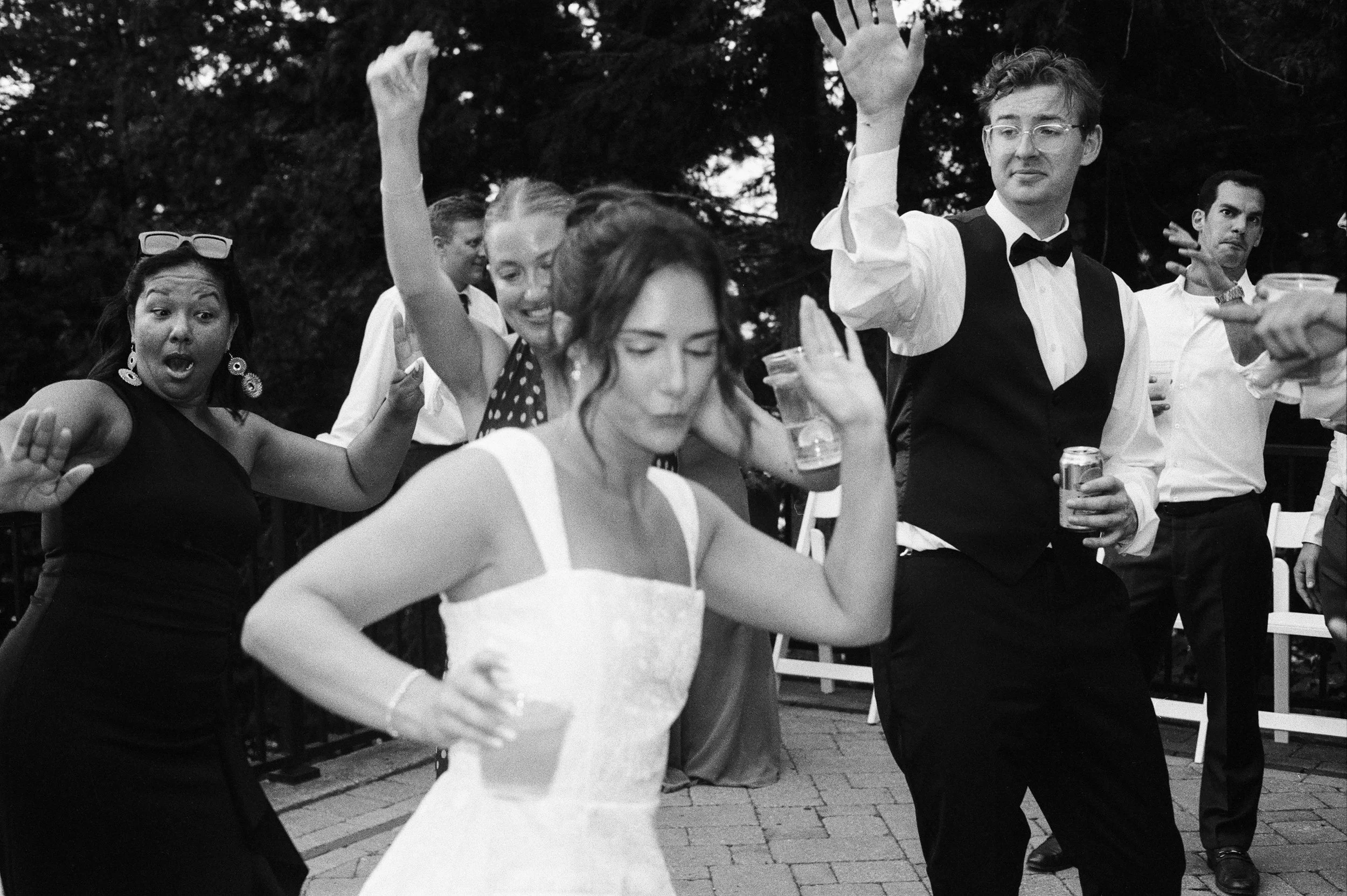 Bride dancing with guests during the lively Northern Michigan backyard wedding celebration.