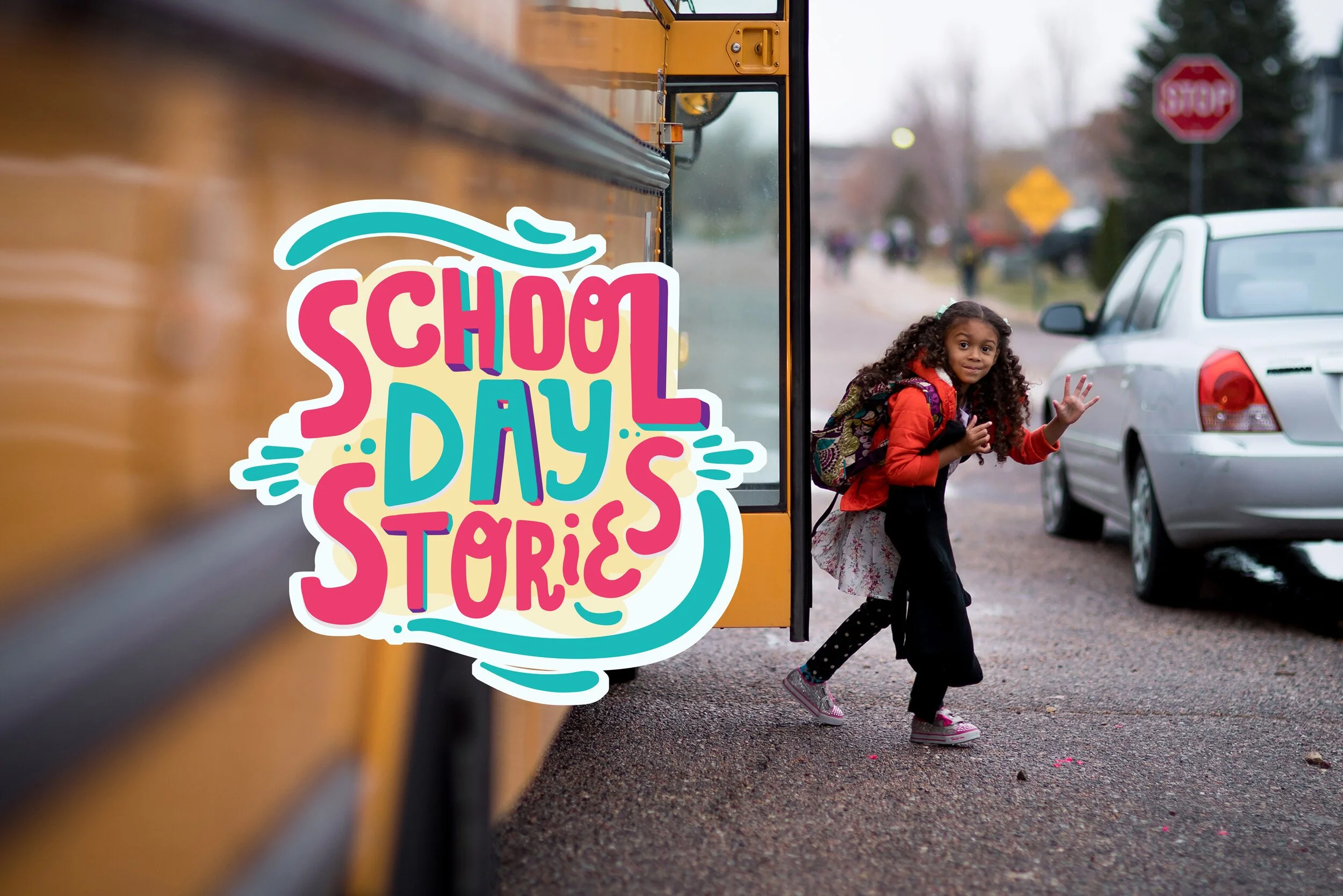 A young girl with curly hair, wearing a red jacket, backpack, and pink shoes, waves as she exits a yellow school bus on a school day.