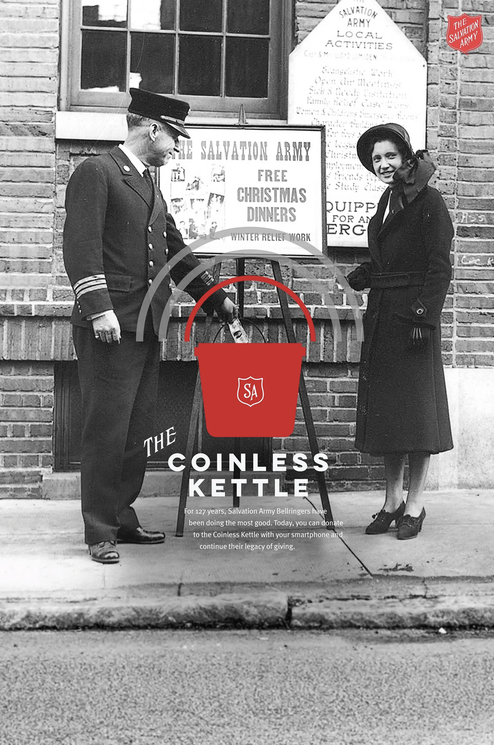 Historical black-and-white photo of a Salvation Army officer and a woman standing outside a brick building with Salvation Army signs. They are pushing a red donation kettle with a smartphone attached, promoting a modern campaign for donations.