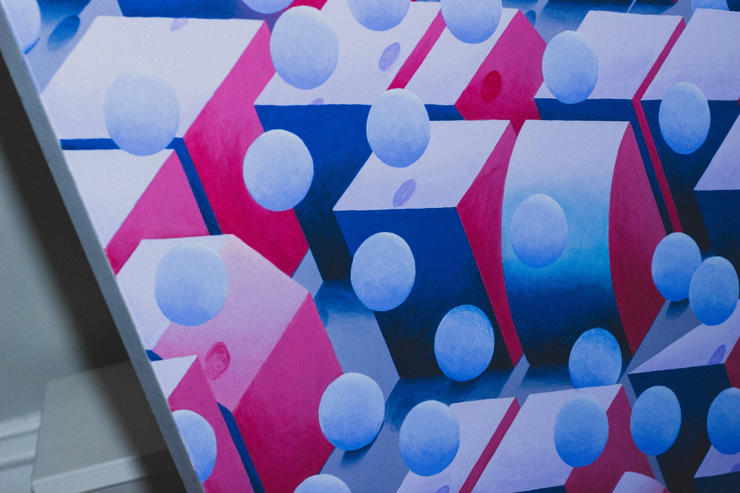 Abstract geometric painting with pink, blue, and purple shapes including circles and cubes.