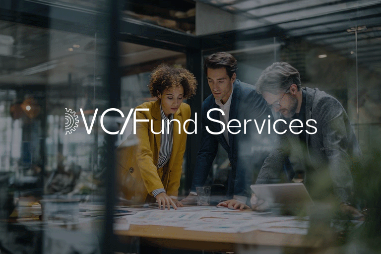 Three business professionals, two men and one woman, collaborating over documents in a glass-walled office space, with the text 'VC Fund Services' overlayed.
