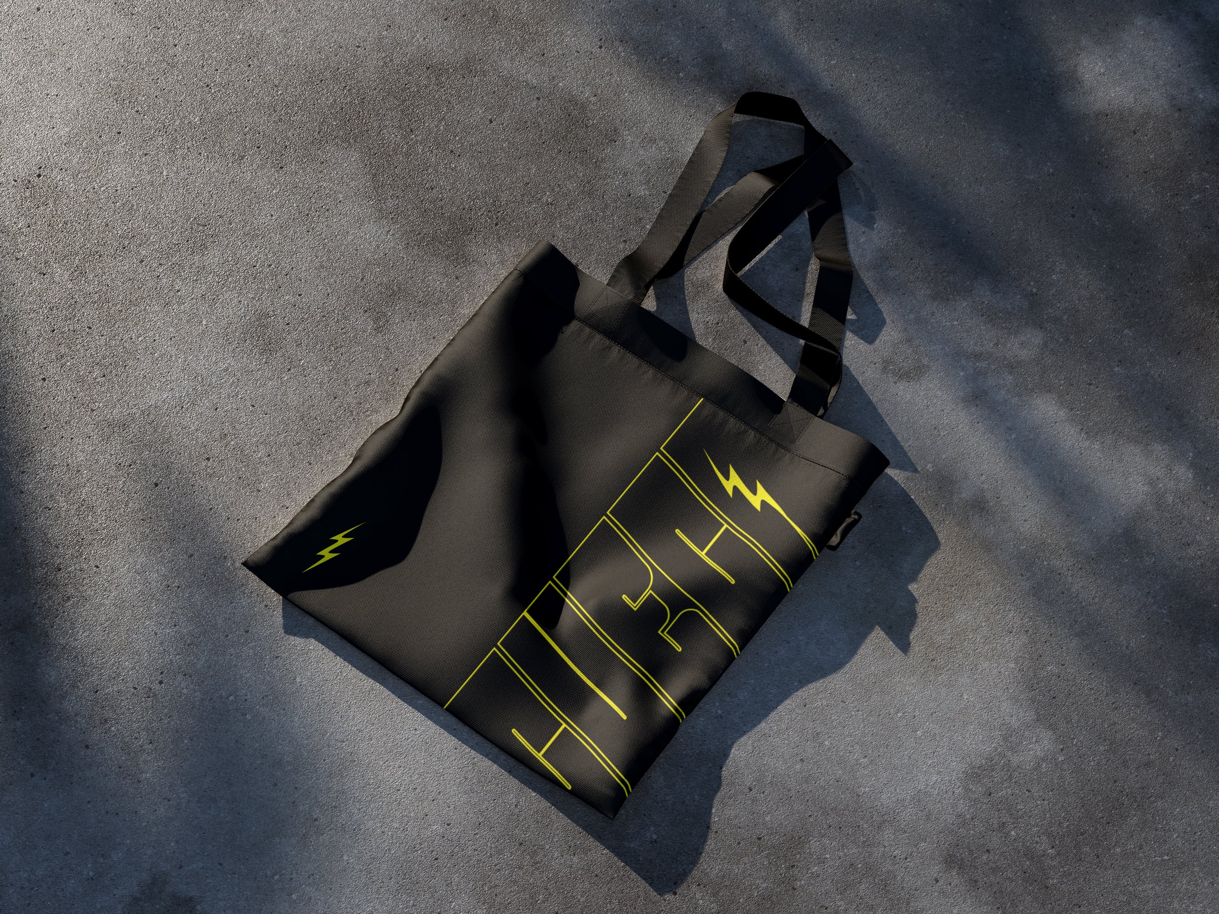 Black bag with yellow lightning bolt design on a textured gray surface.