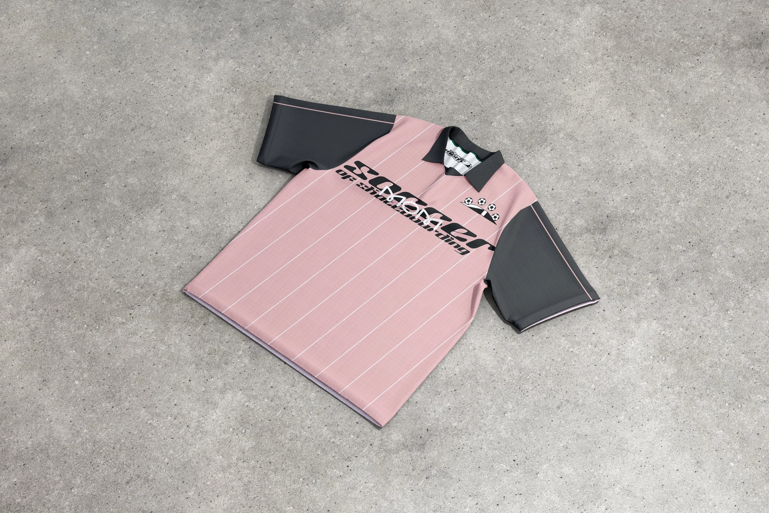 Pink and black striped sports shirt with text and graphics on a light gray surface.