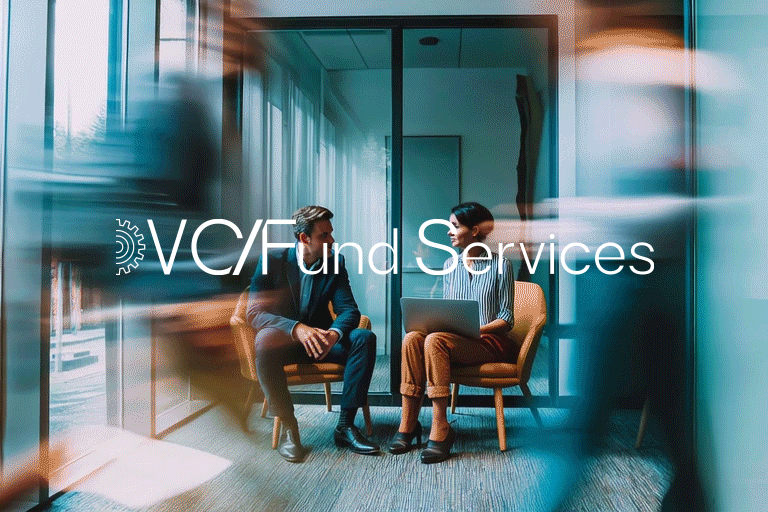 A man and a woman sitting and talking in an office lounge area with glass walls. The woman has a laptop on her lap. The image has a overlay text that reads 'VC Fund and Services'.