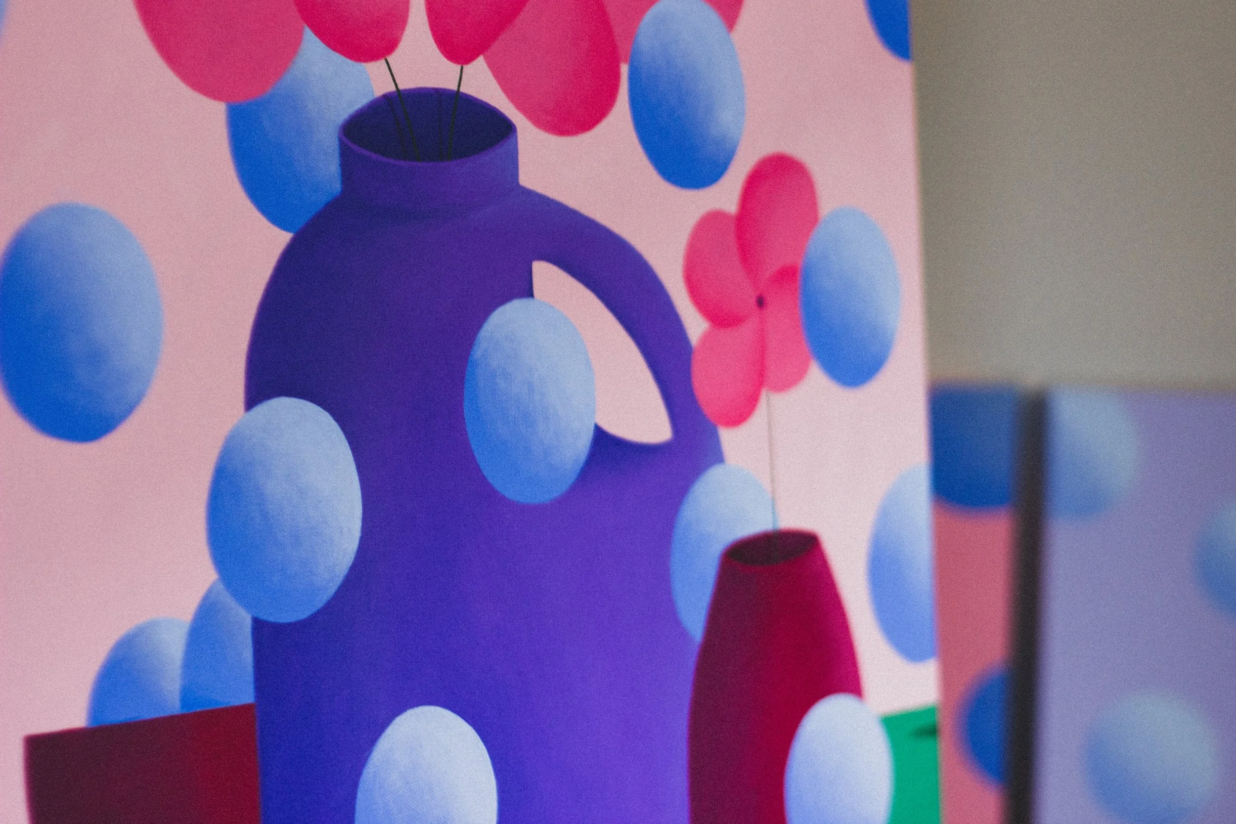 A colorful abstract painting featuring a large purple vase with pink and blue balloons, pink butterflies, and a pink background.