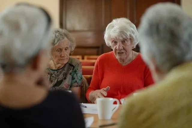 older adults participating in a group conversation during speech therapy support for Parkinson’s disease
