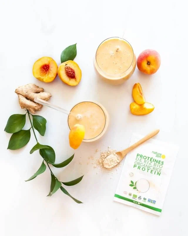 smoothies peaches and soft foods arranged on a table representing safe nutrition ideas for Parkinson’s swallowing therapy