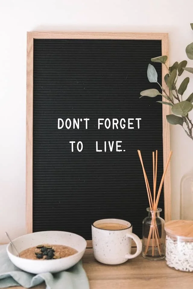 Letterboard sign reading 'Don't forget to live' used to illustrate memory strategies, reminders, and compensatory supports in aphasia therapy.
