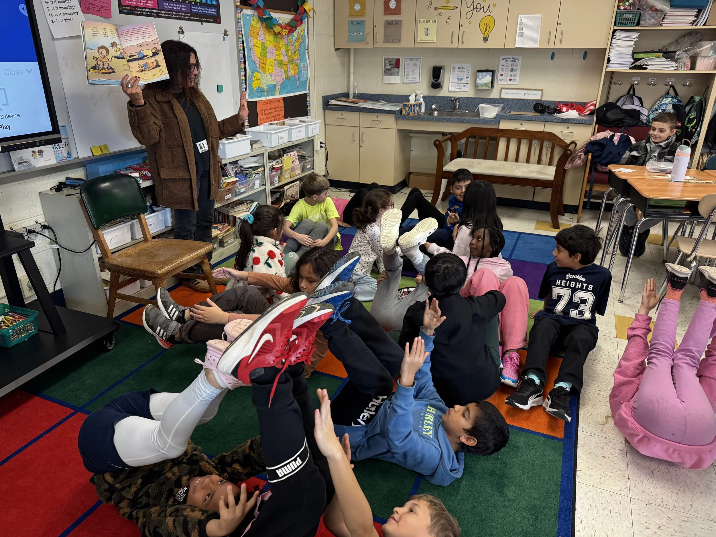 Hiba reading to children from her book I Feel Better Now.