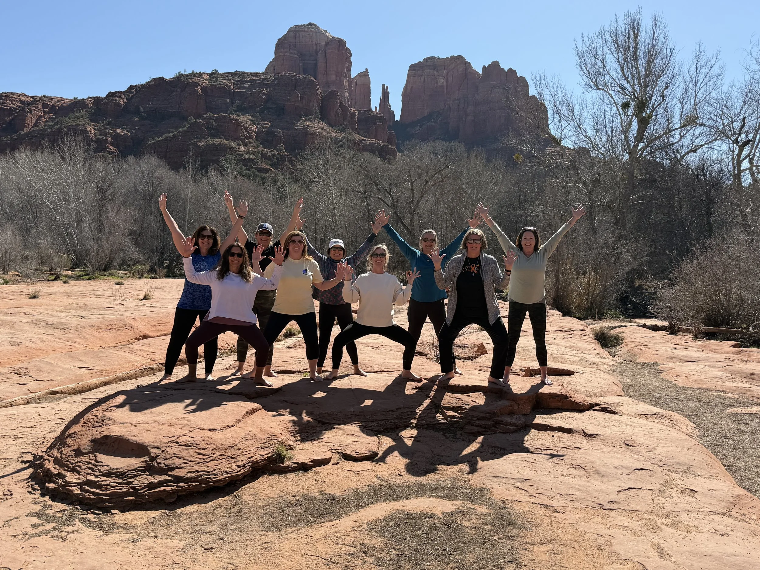Sedona Retreat attendees pose in front of Sedona rock formations.