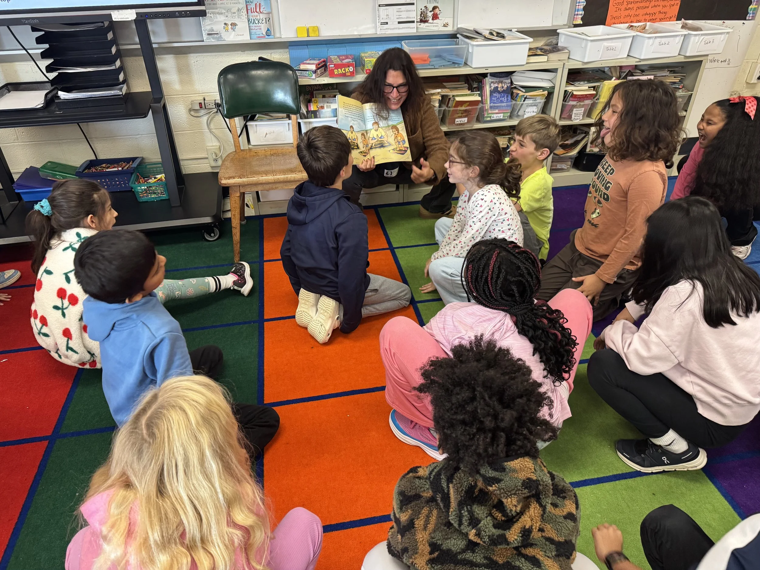 Hiba reading I Feel Better Now to children.