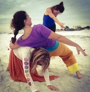 Cheryl Pallant and others performing Contact Improvisation on a beach.