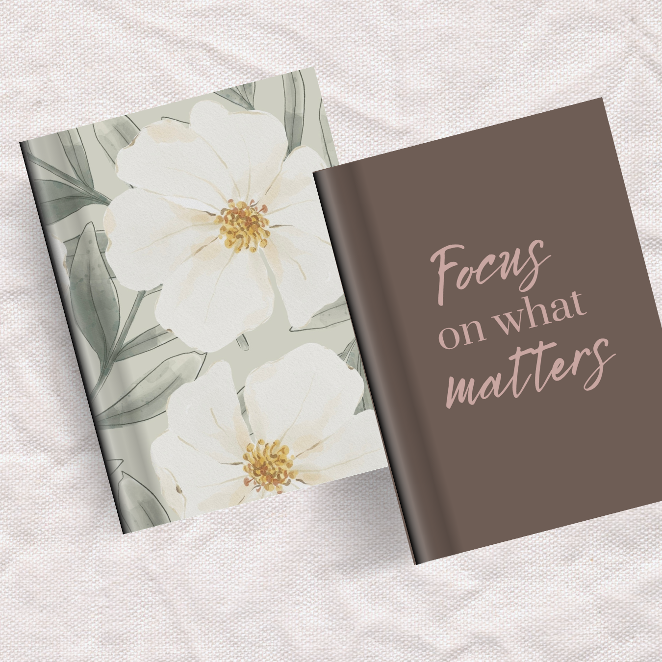 An open book with a floral cover on the left showing white flowers with yellow centers, and a page on the right displaying the phrase 'Focus on what matters' in pink and white text on a brown background.