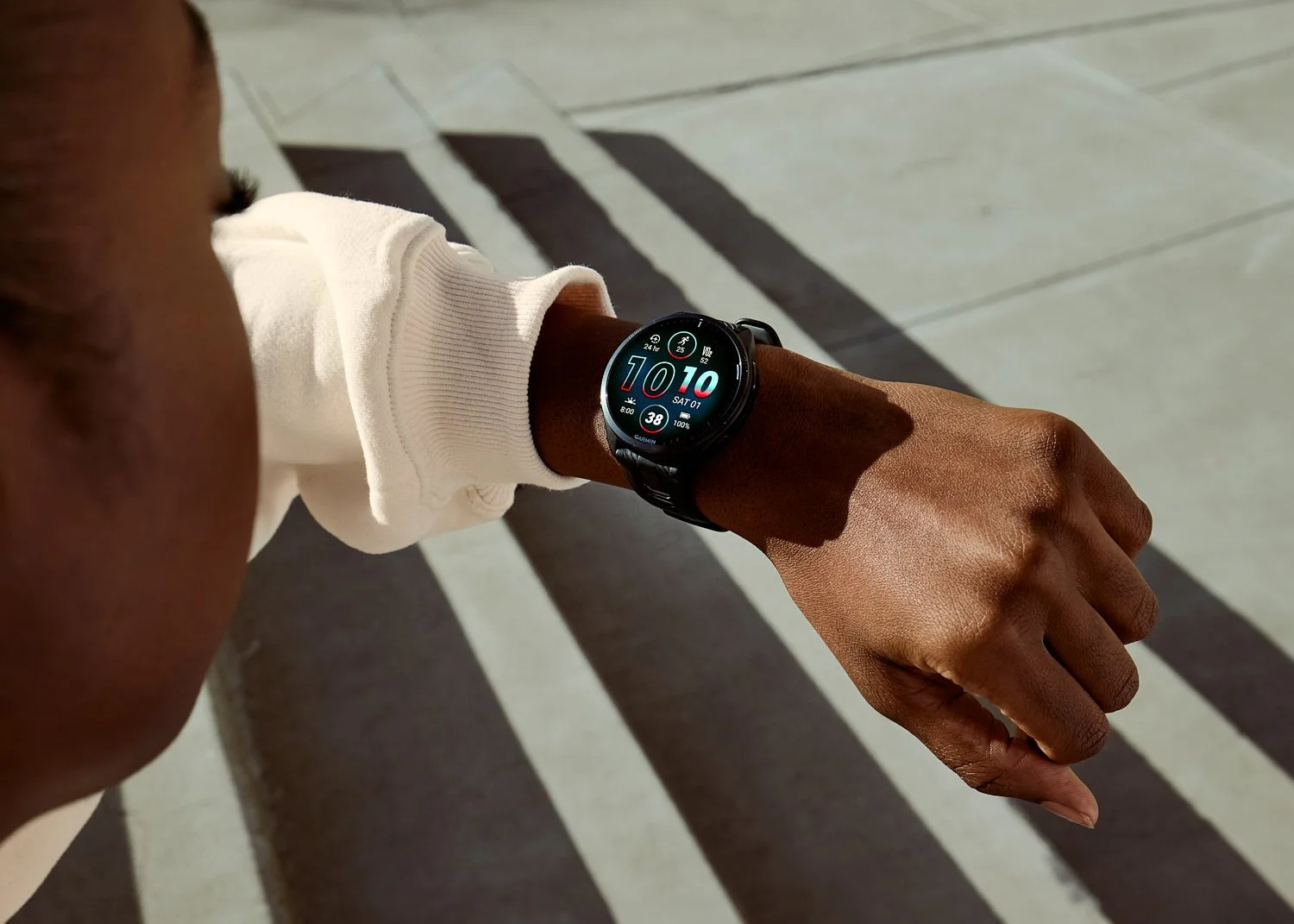 Athlete checking Garmin sports watch in early morning sunlight in Arizona