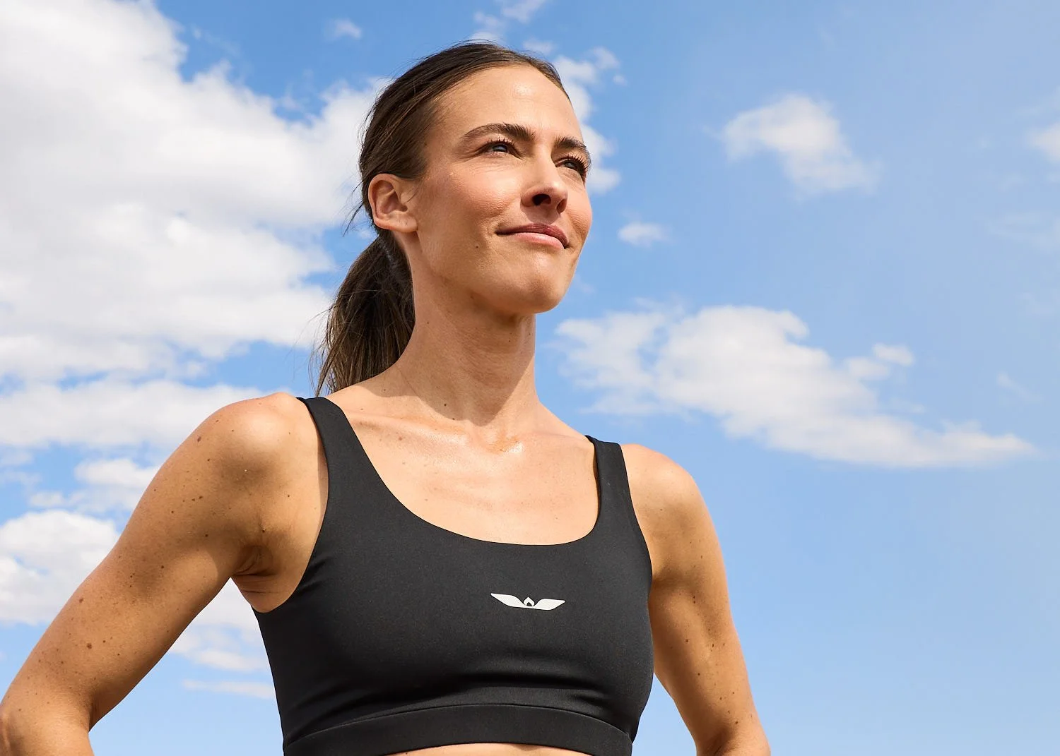 Runner looking off into distance with sky as backdrop