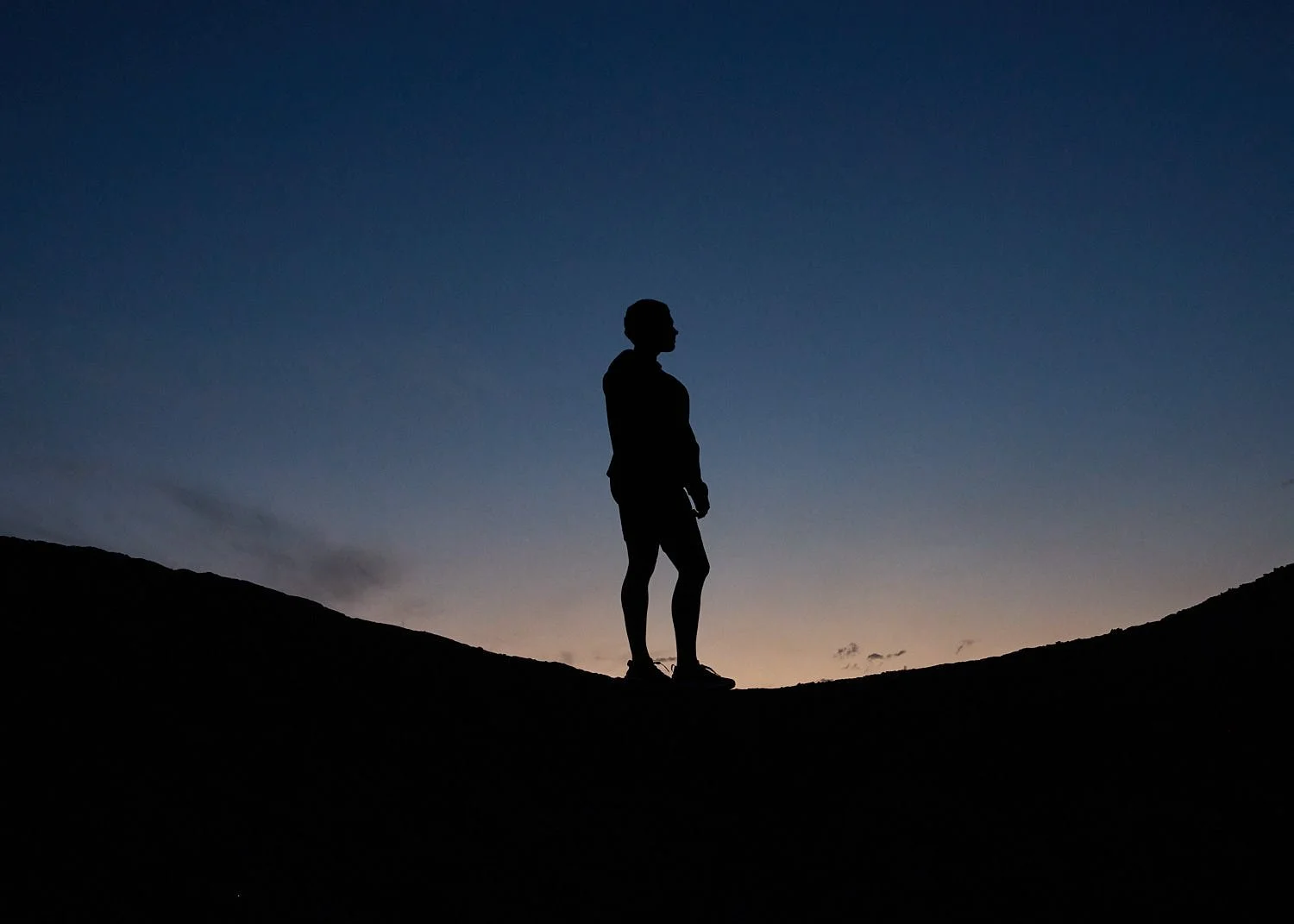 Commercial lifestyle shot of athlete in Unitus sportswear posing in Sedona at dusk.