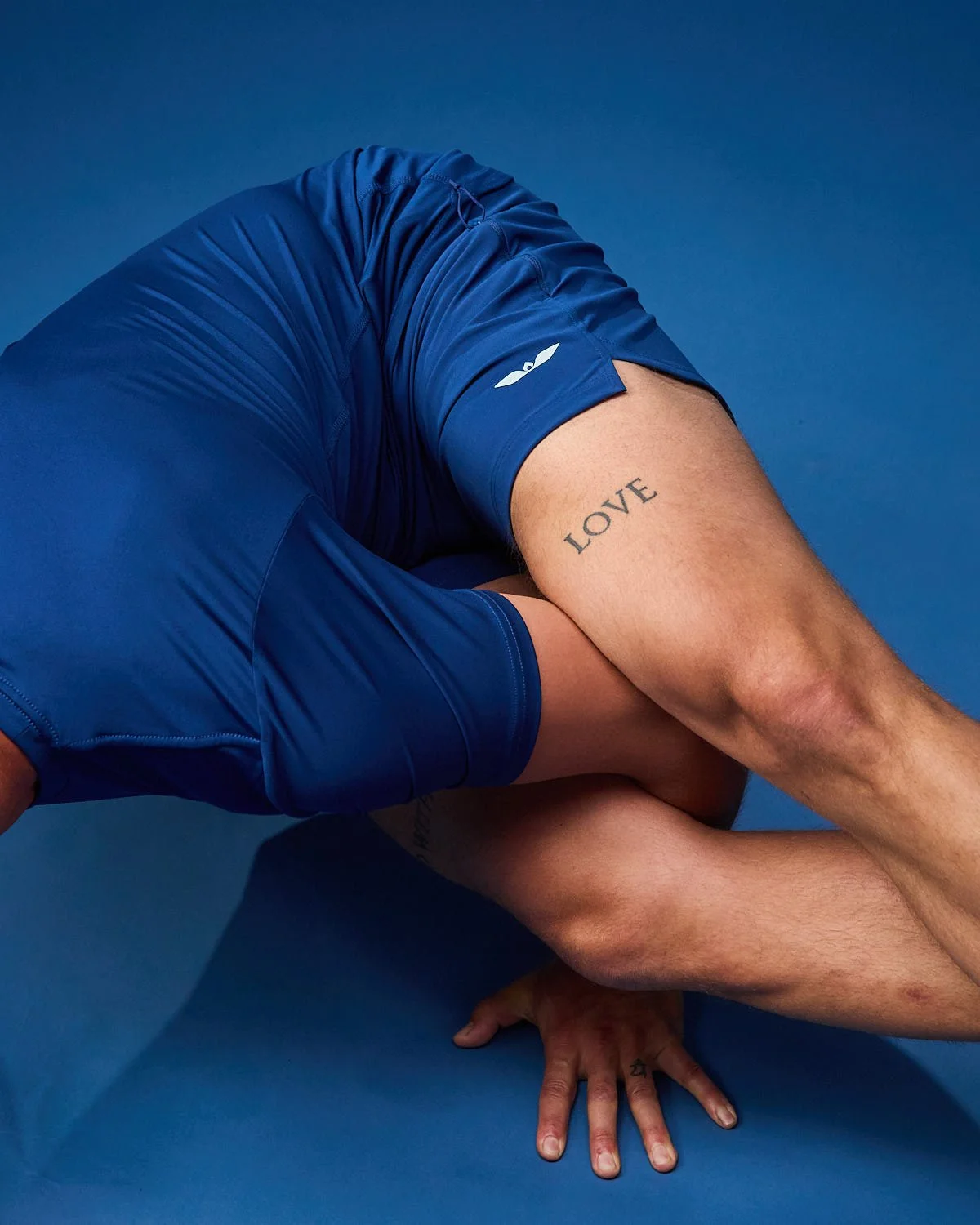 Men's blue fitness shorts photographed in studio