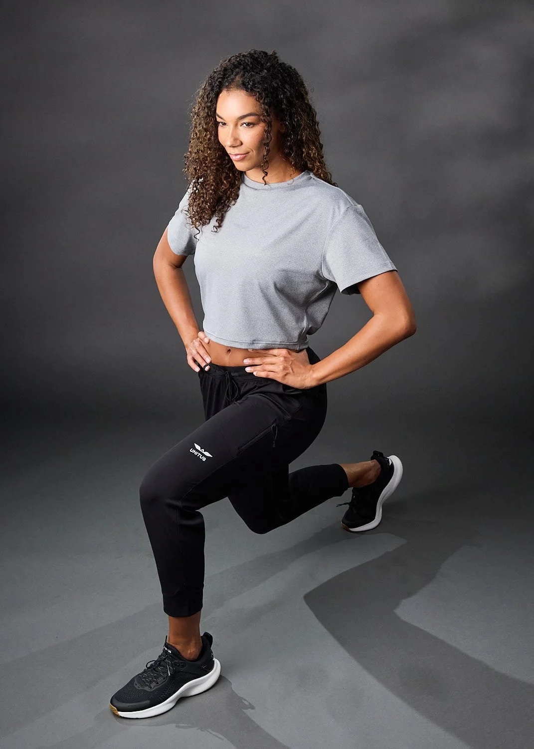 Women’s athletic heather gray shirt, photographed with clean studio lighting