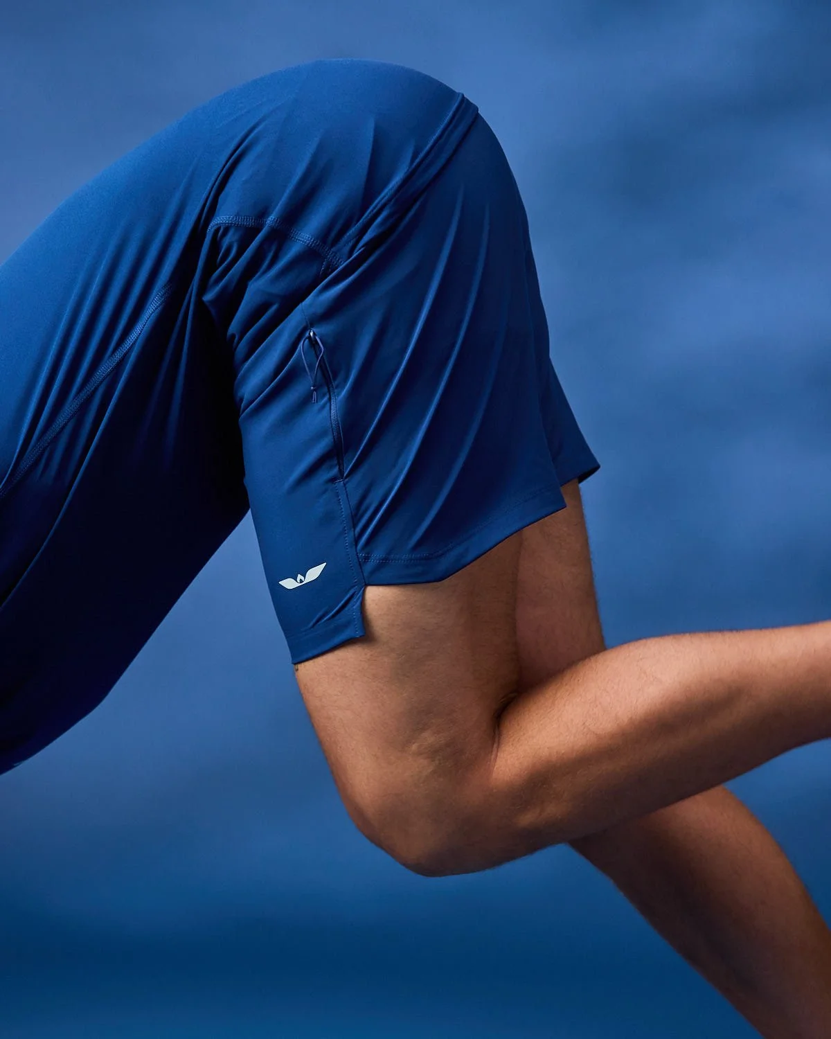 Men's blue running shorts, photographed with clean studio lighting