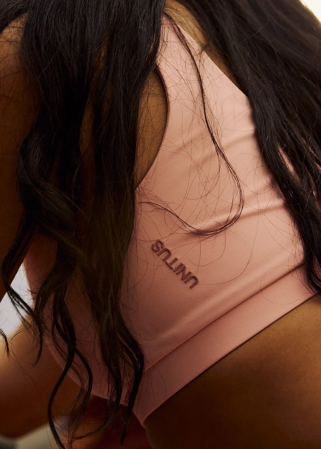 Commercial lifestyle close up shot of brand logo on sports bra