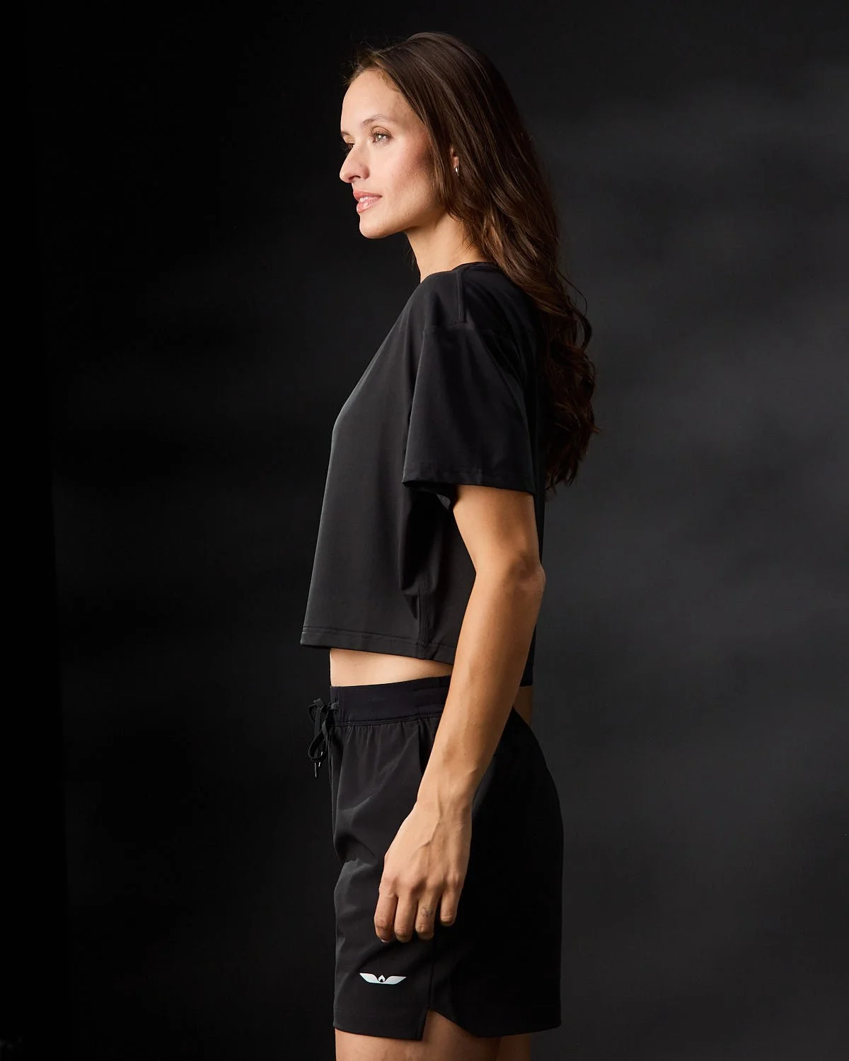Women's black shirt, photographed with clean studio lighting on black background