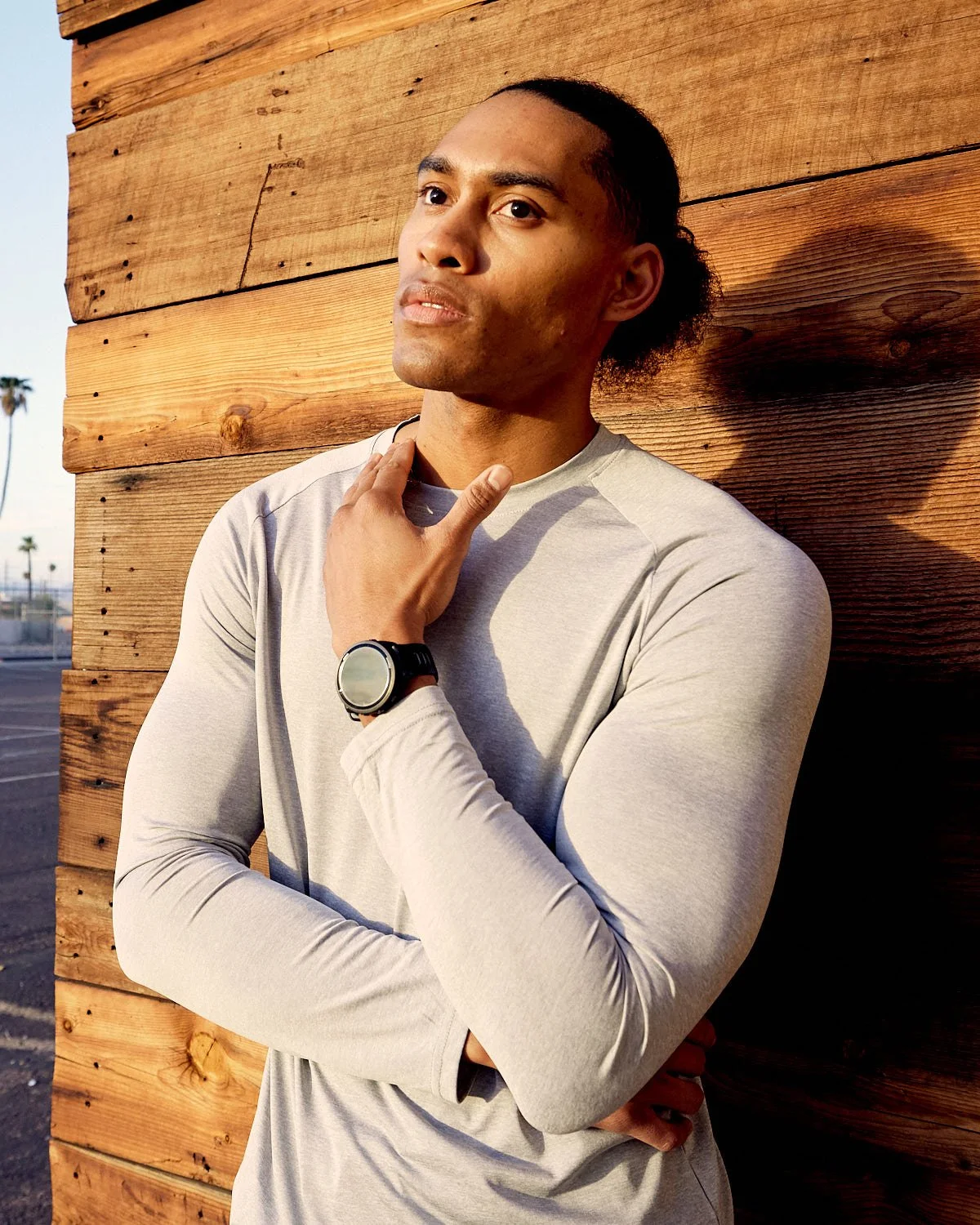 Athlete standing with Garmin watch on wrist, photographed by Matthew Keough