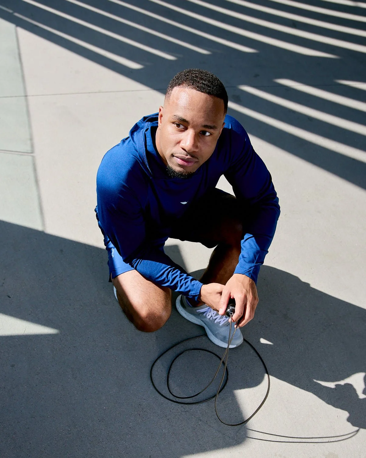 Athlete resting in sportswear after jumping rope