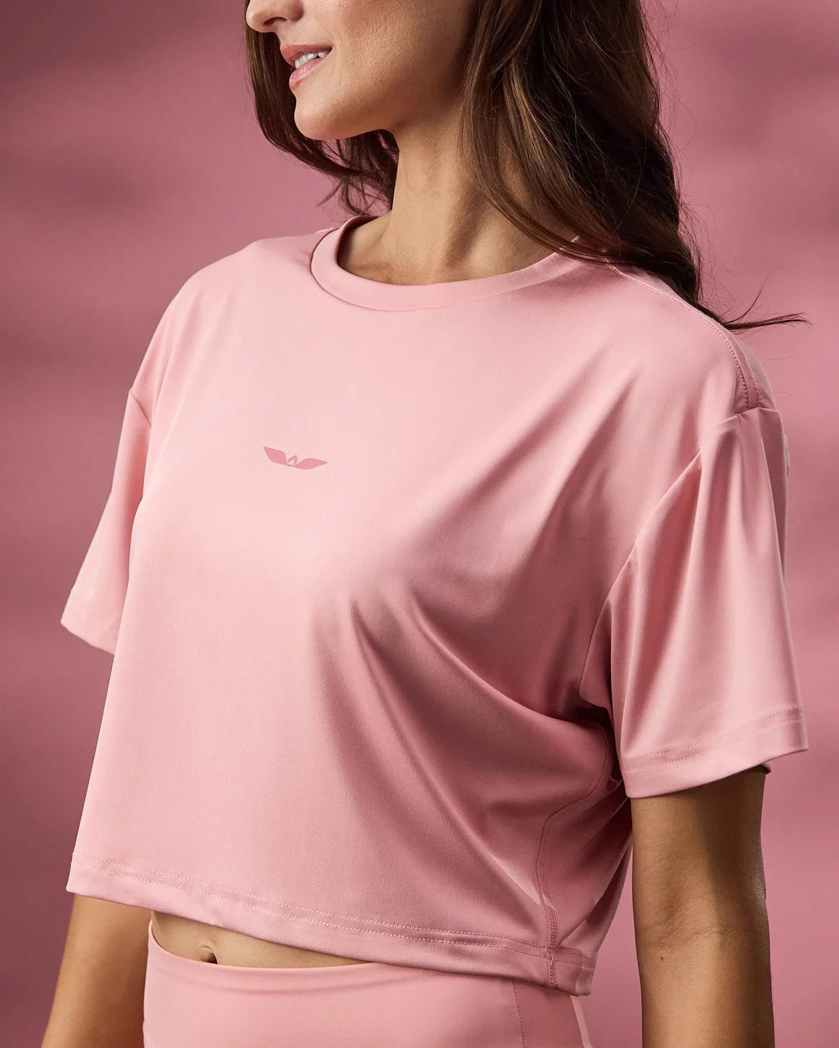 Women's rose pink shirt, photographed with clean studio lighting with pink backdrop