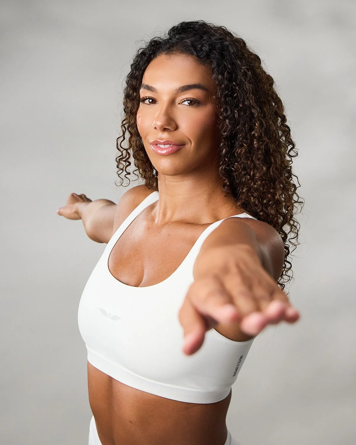 Women's white sports bra, photographed with clean studio lighting