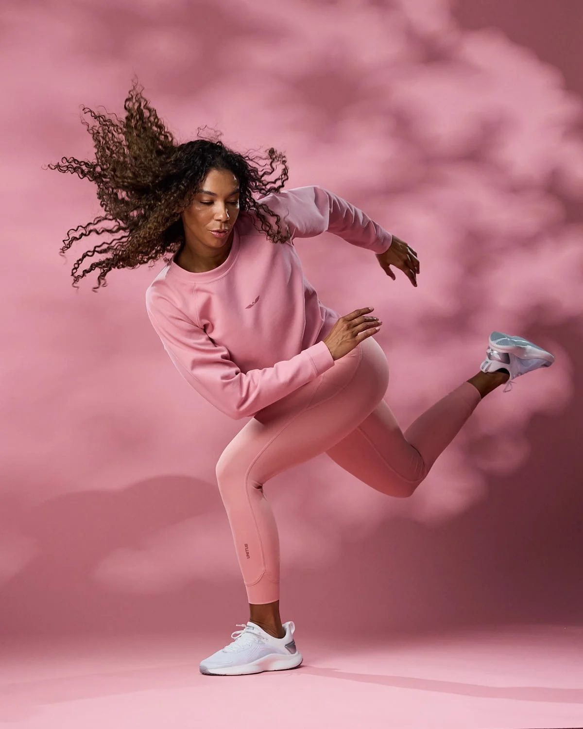 Women’s athletic pink leggings and jacket, photographed with clean studio lighting