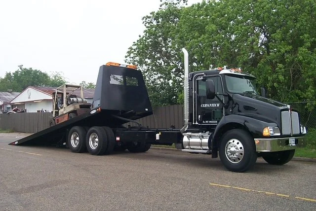 Commercial waste compactor being transported for installation by Cervantech Sales in Texas